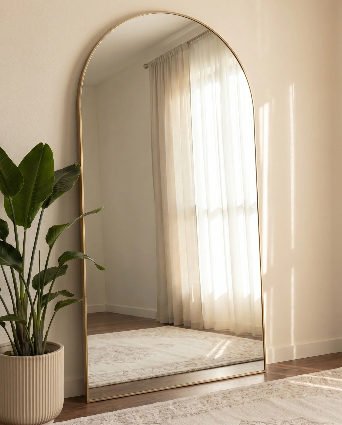 Large arched wall mirror with a golden frame