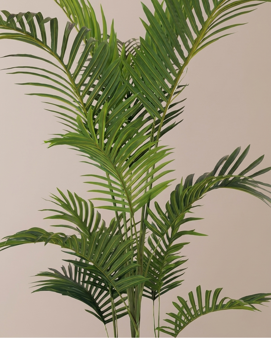 A green palm-like artificial plant with long, slender fronds against a plain beige background.