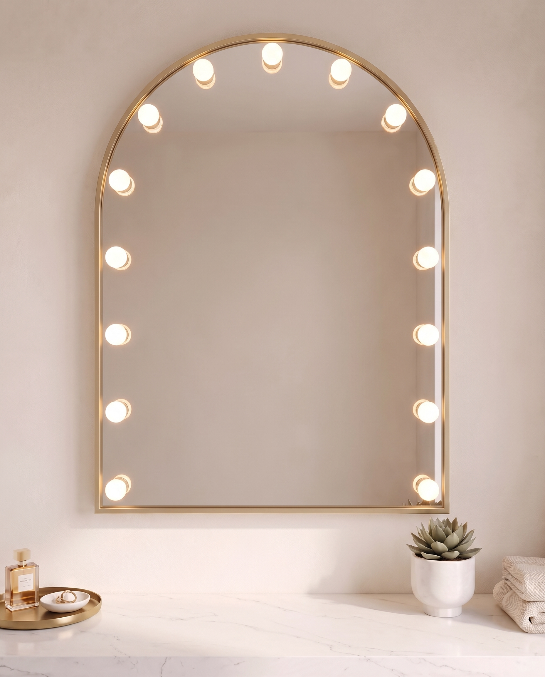 Soraya gold arch wall mirror with bulbs in a Dubai bathroom