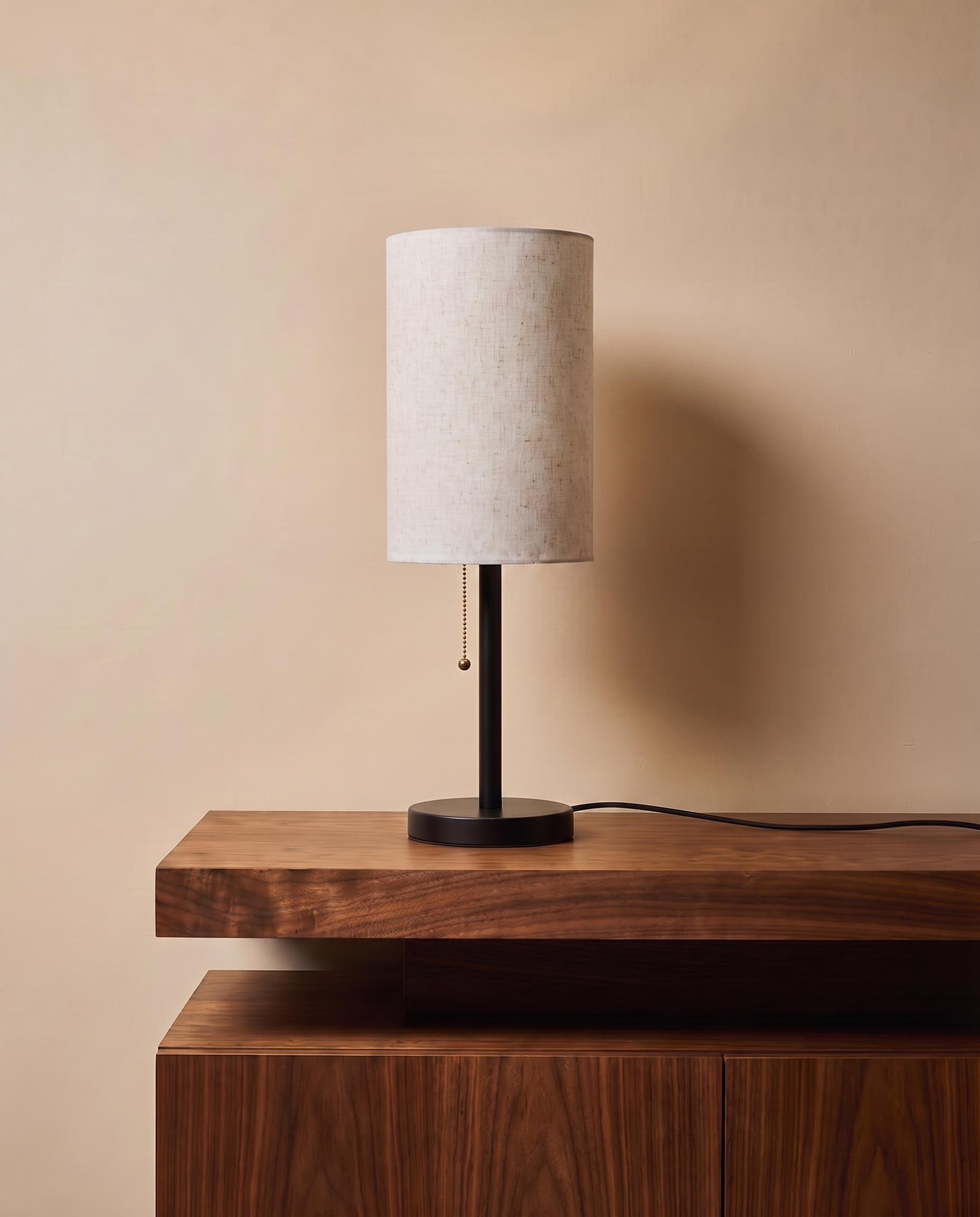 Black table lamp with tall off-white shade
