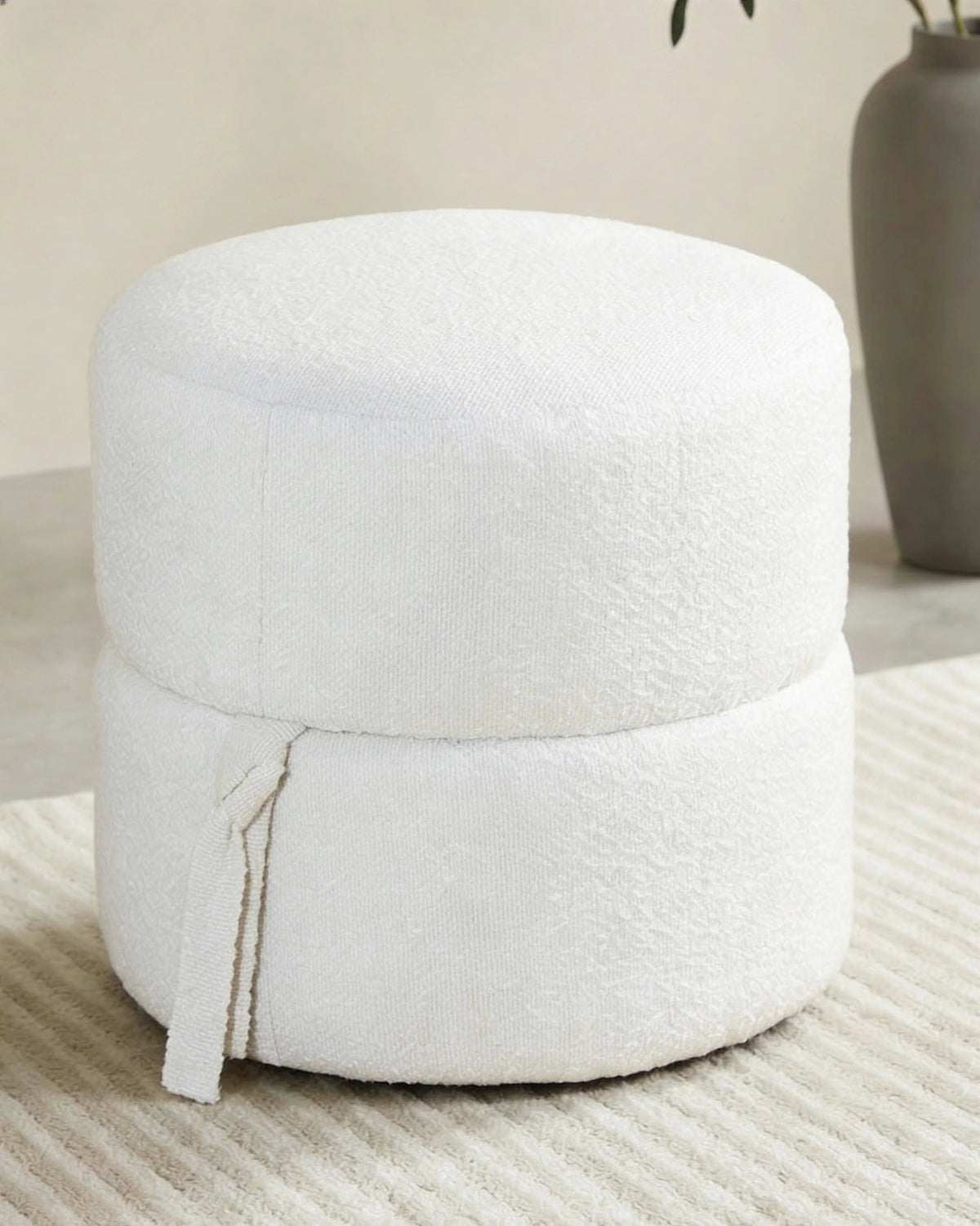 Round bouclé pouf, close-up of the fabric texture
