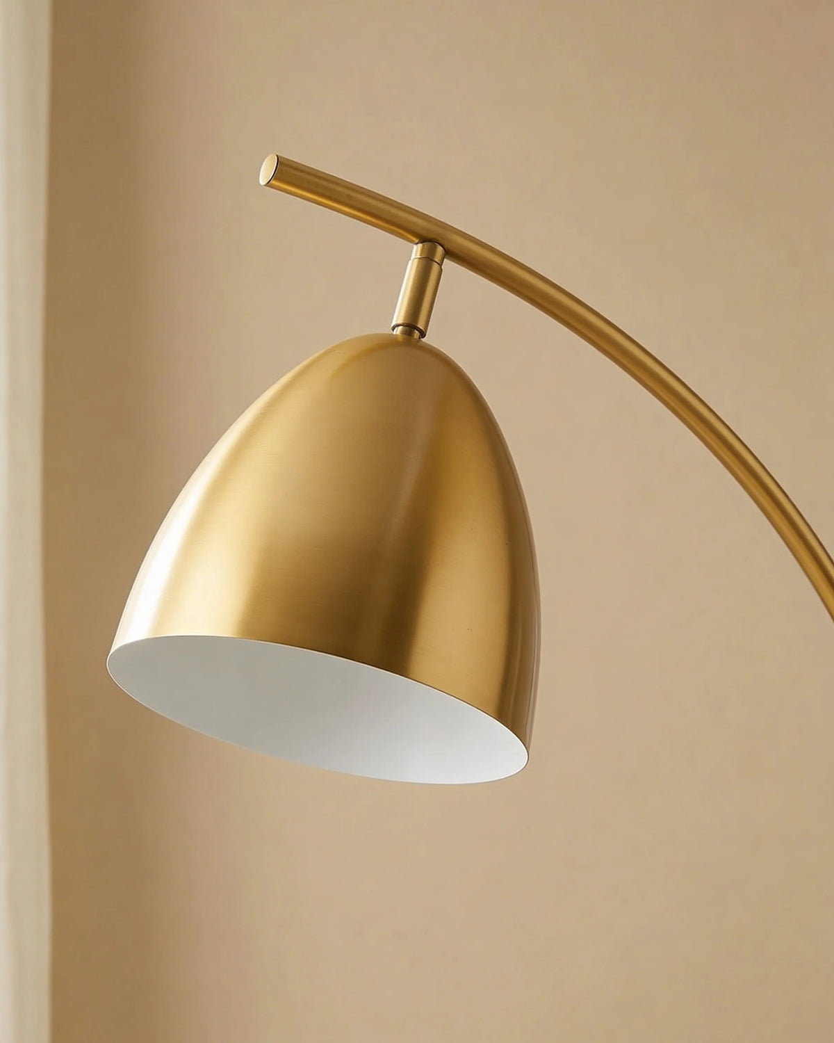 Gold arched floor lamp with table in a Dubai living room