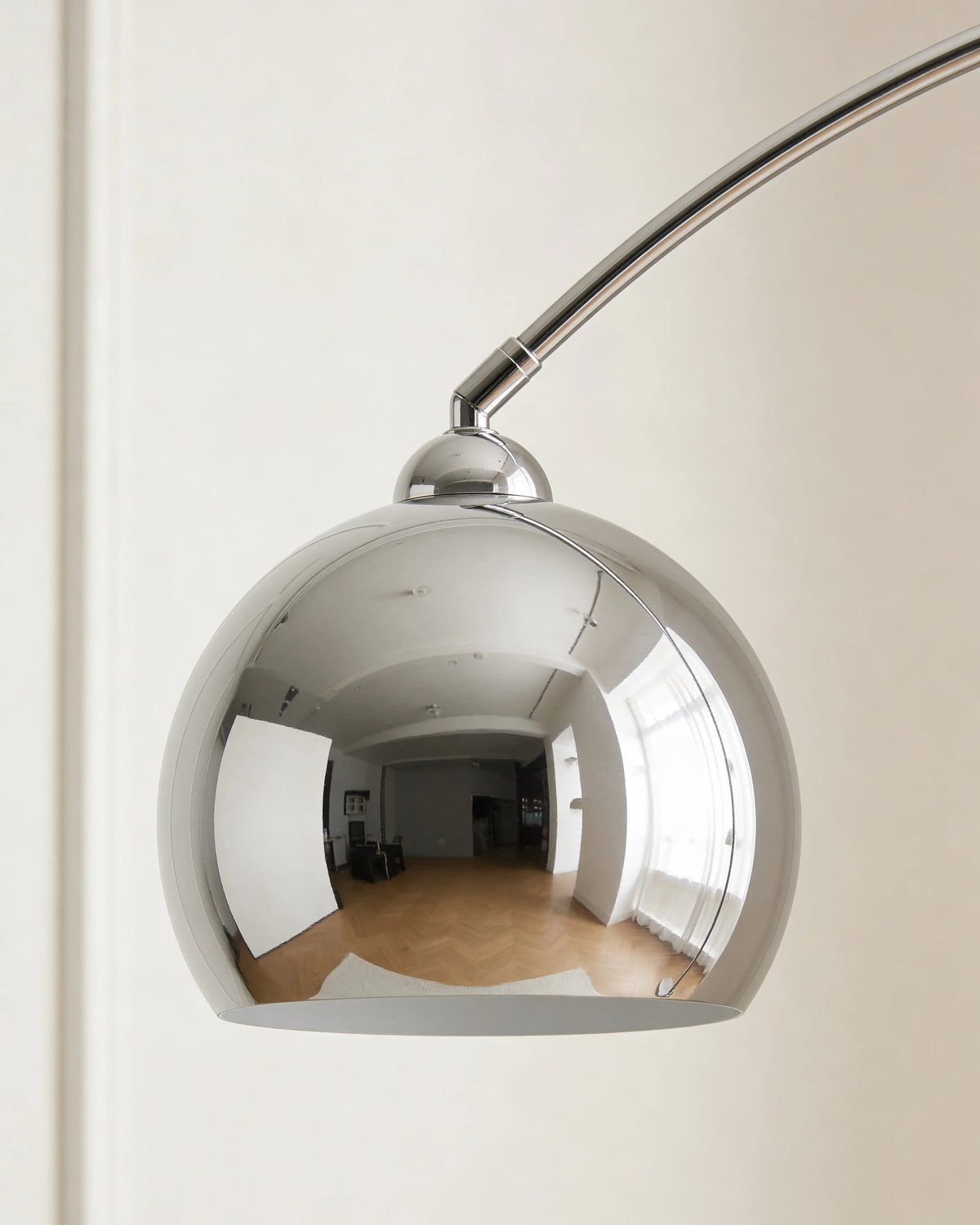 Silver arc floor lamp in a Dubai living room