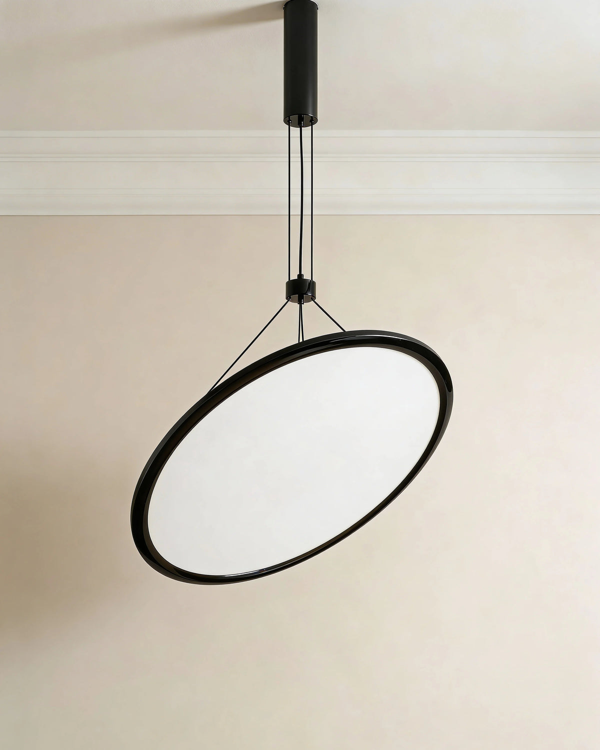 Black disc pendant light over a Dubai dining table