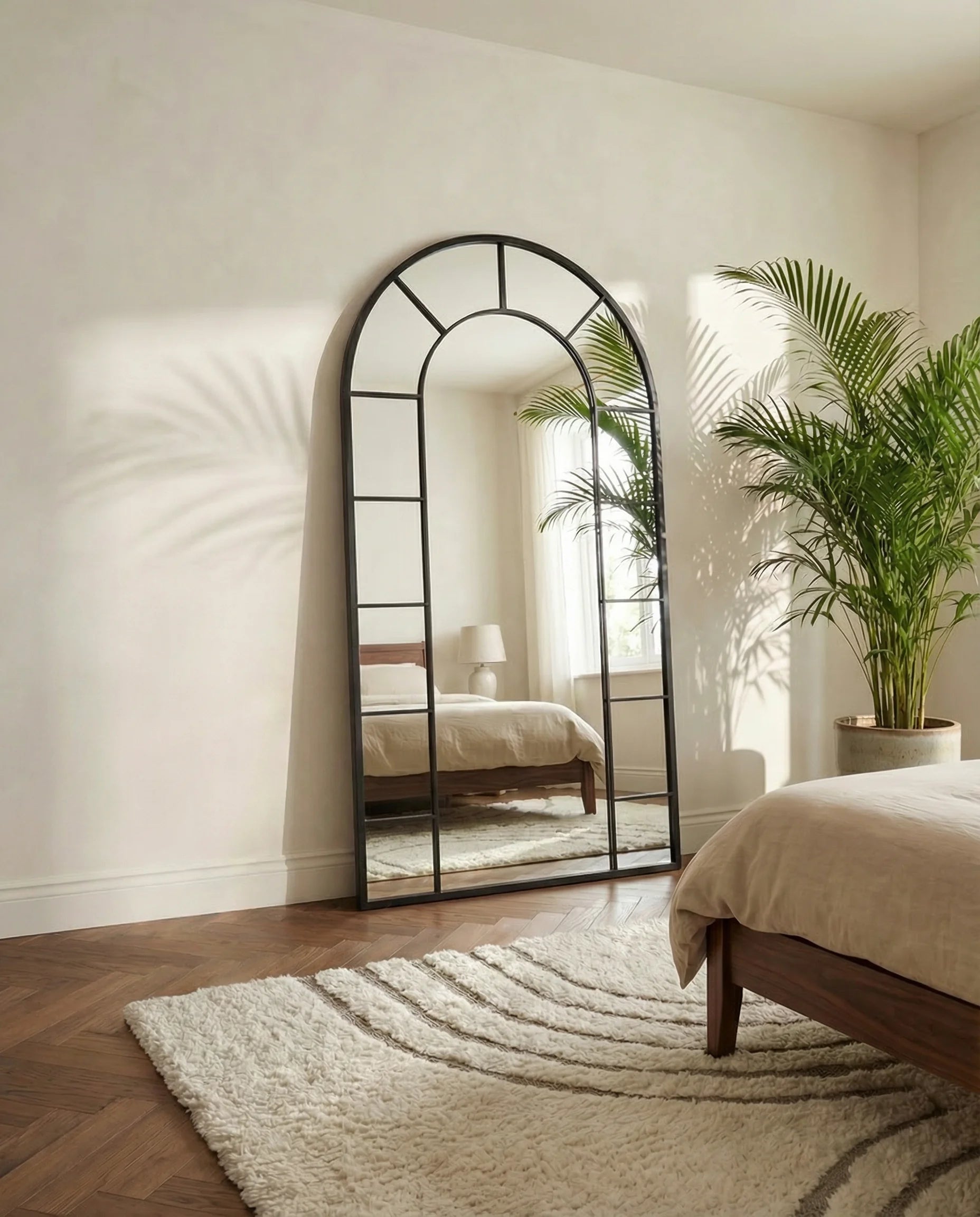 Charles black window-pane arched mirror in a Dubai living room
