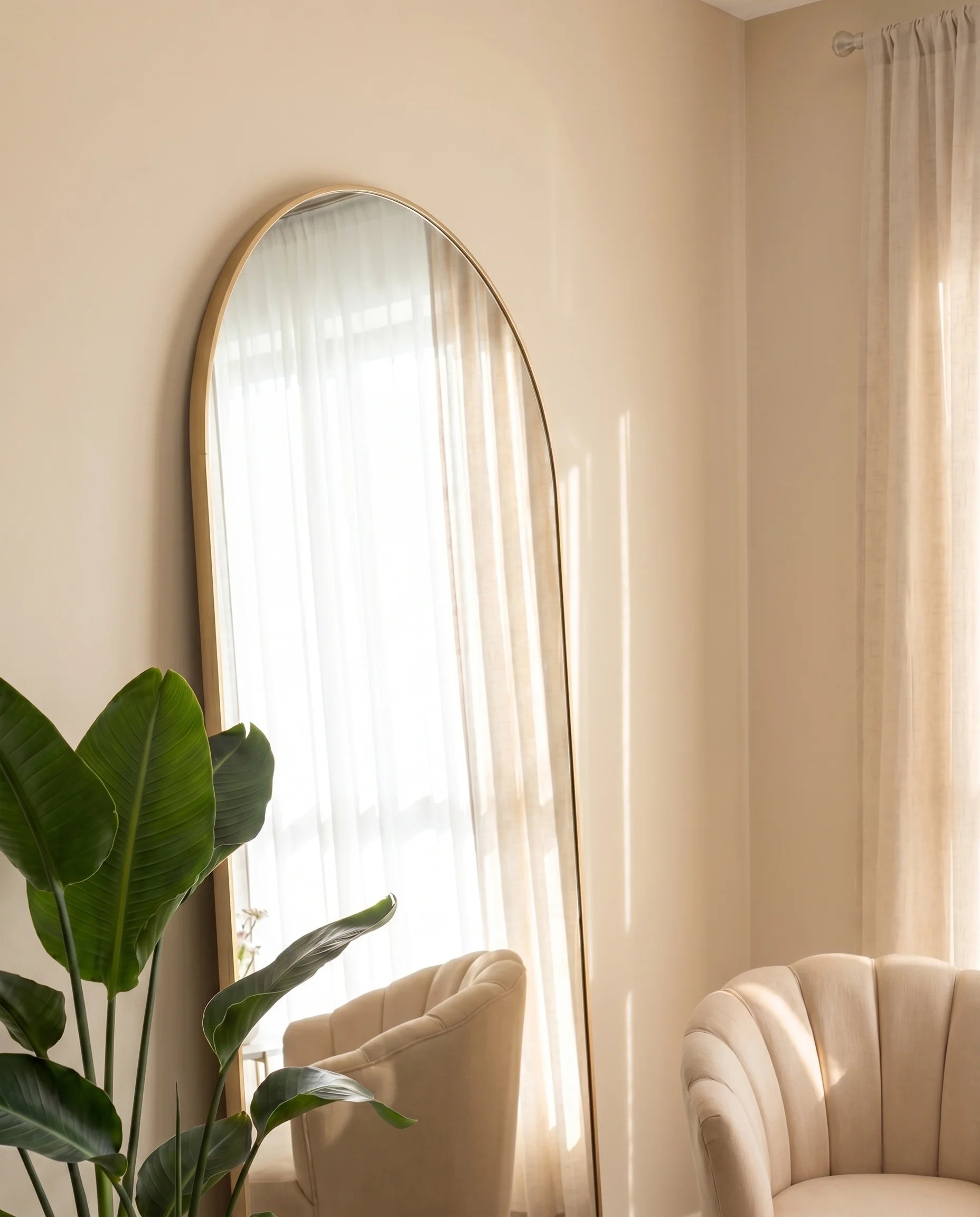 Diana large arched gold mirror in a Dubai living room