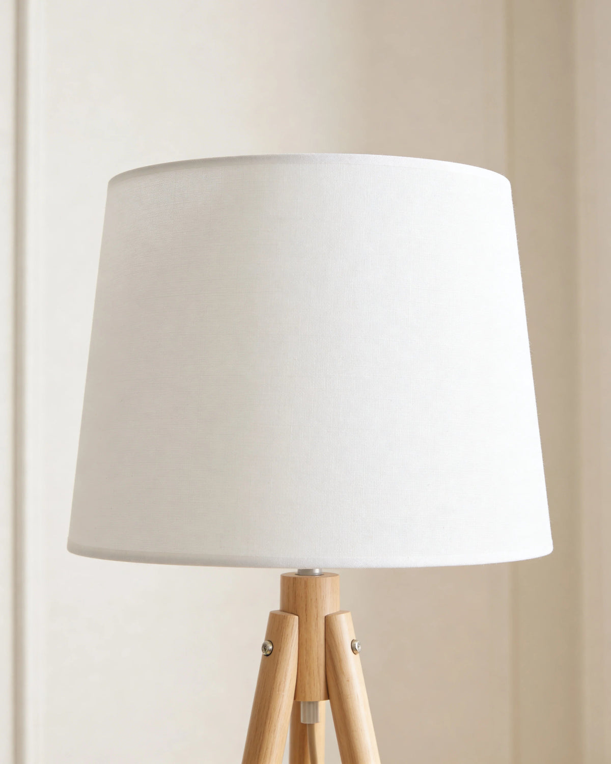 Wooden tripod floor lamp in a Dubai living room