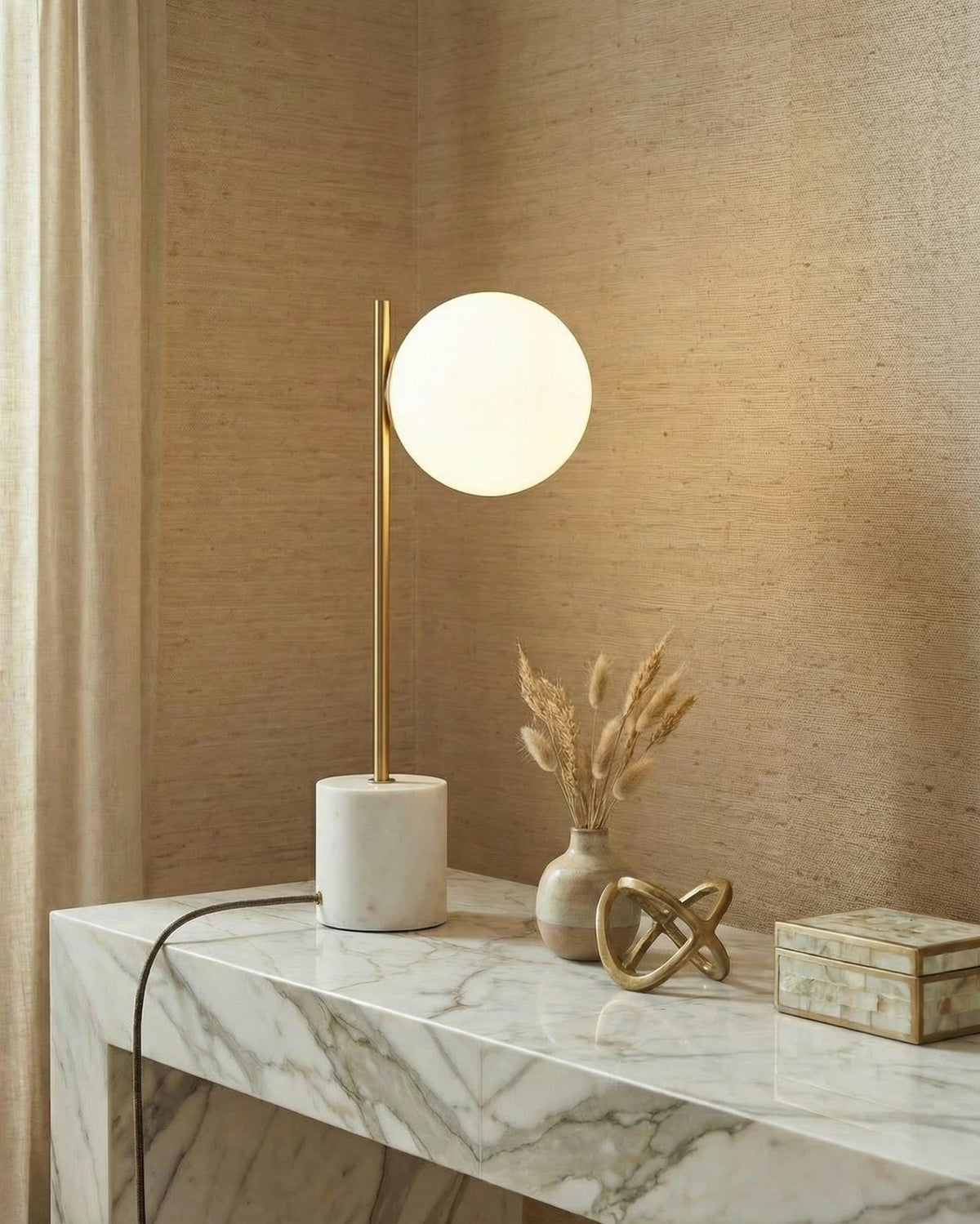 Fiona globe table lamp with a glowing glass globe