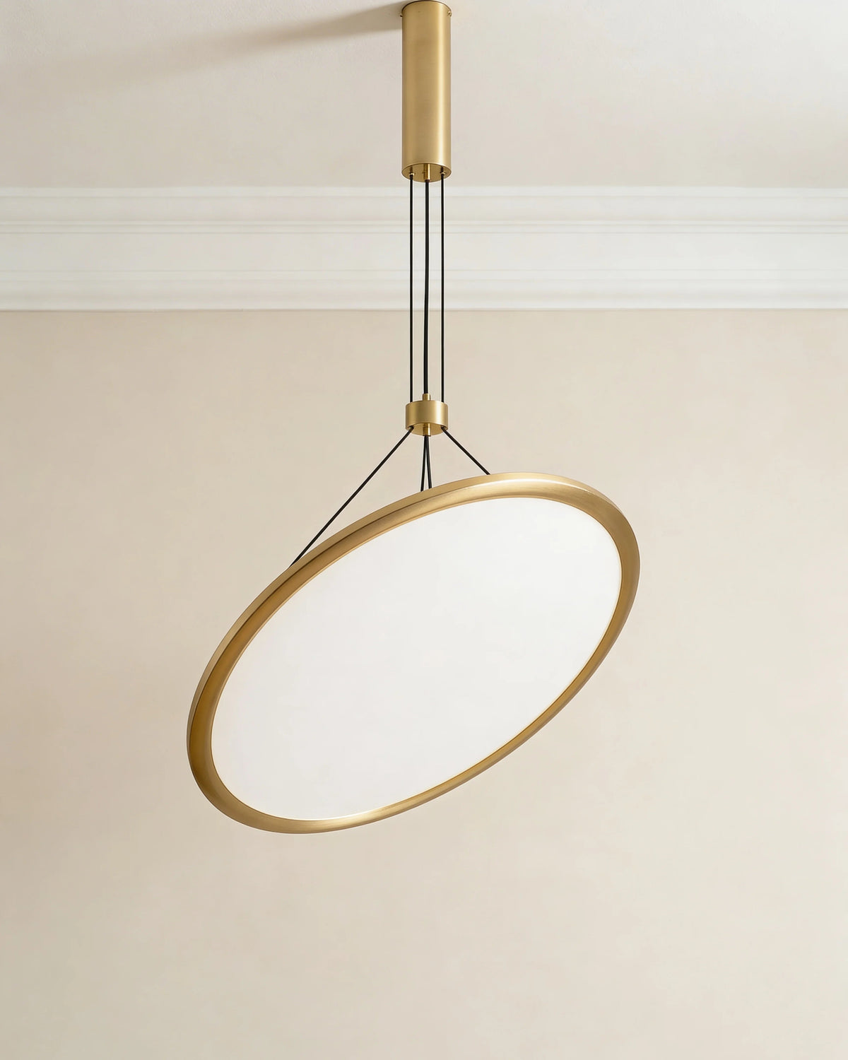 Gold disc pendant light over a Dubai dining table