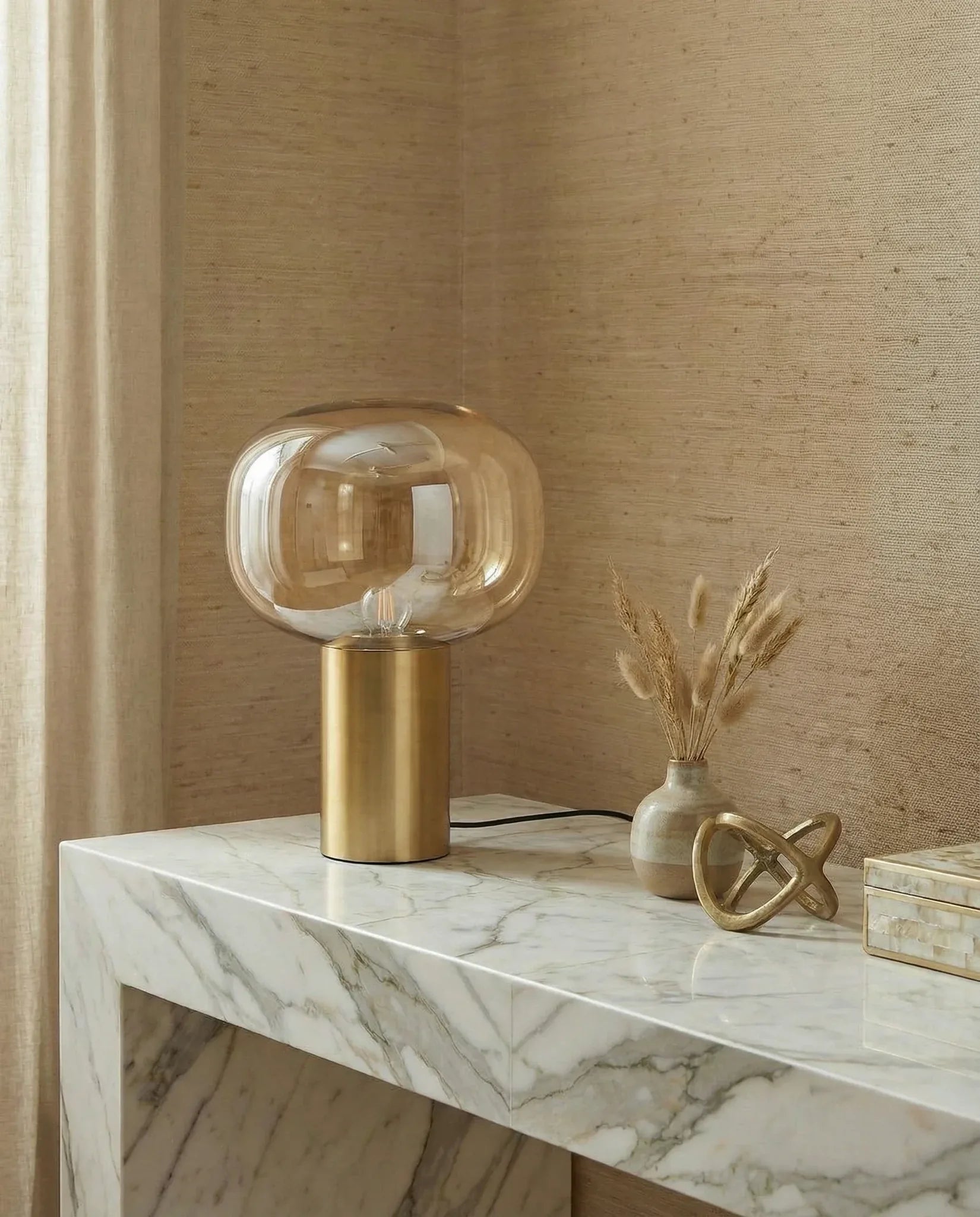 Golden Bonbori glass table lamp on a console