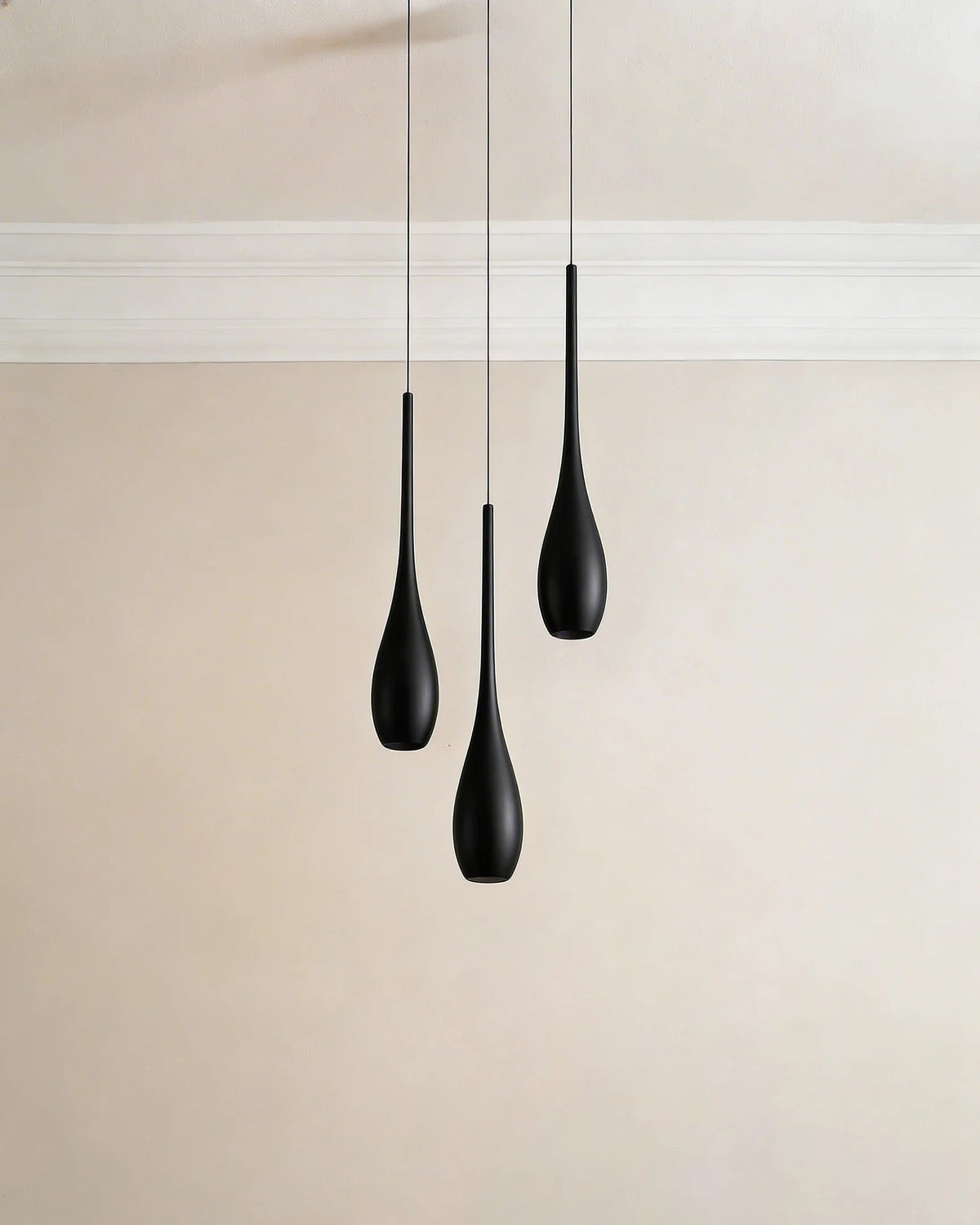 Black water-drop pendant light in a Dubai dining room