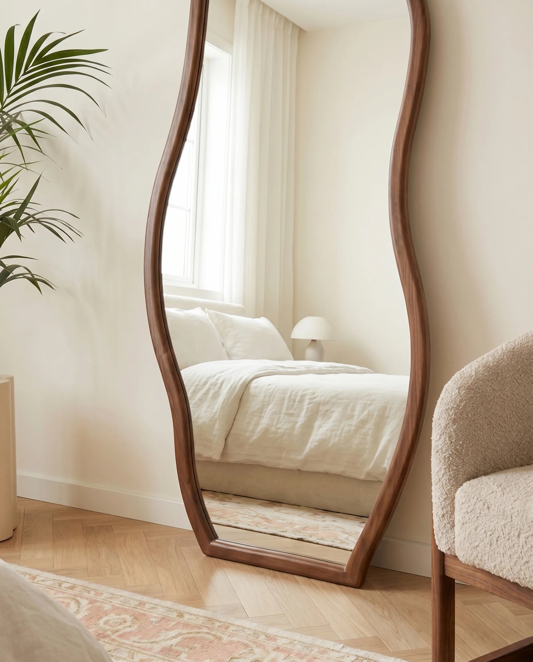 Hazel dark brown wavy mirror, close-up of the wood-tone frame