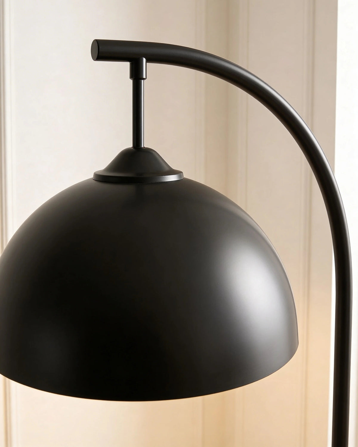 Black arc floor lamp with shelves in a Dubai living room