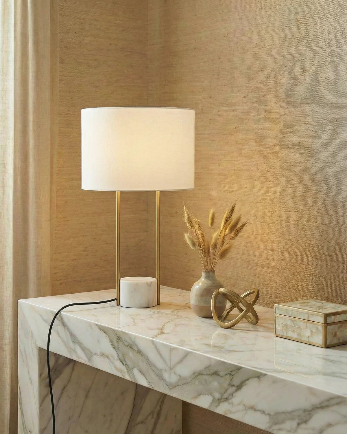 Modern gold rod bedside table lamp on a marble base