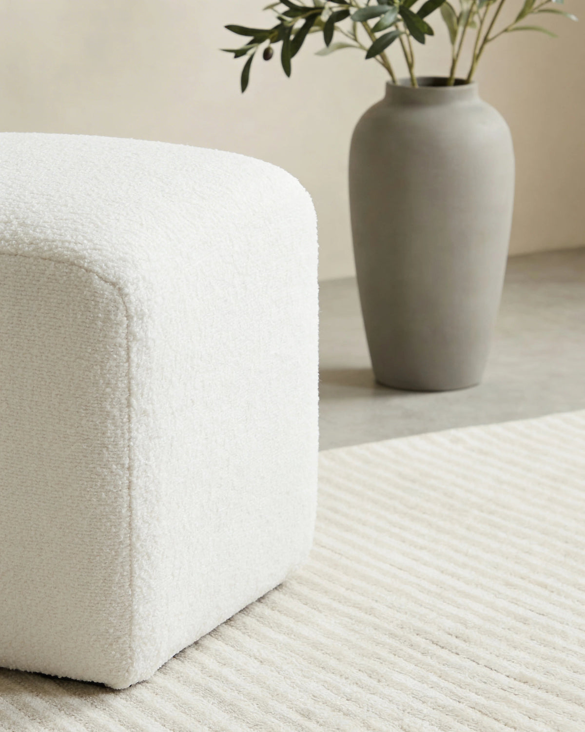 White square pouf, close-up of the upholstery