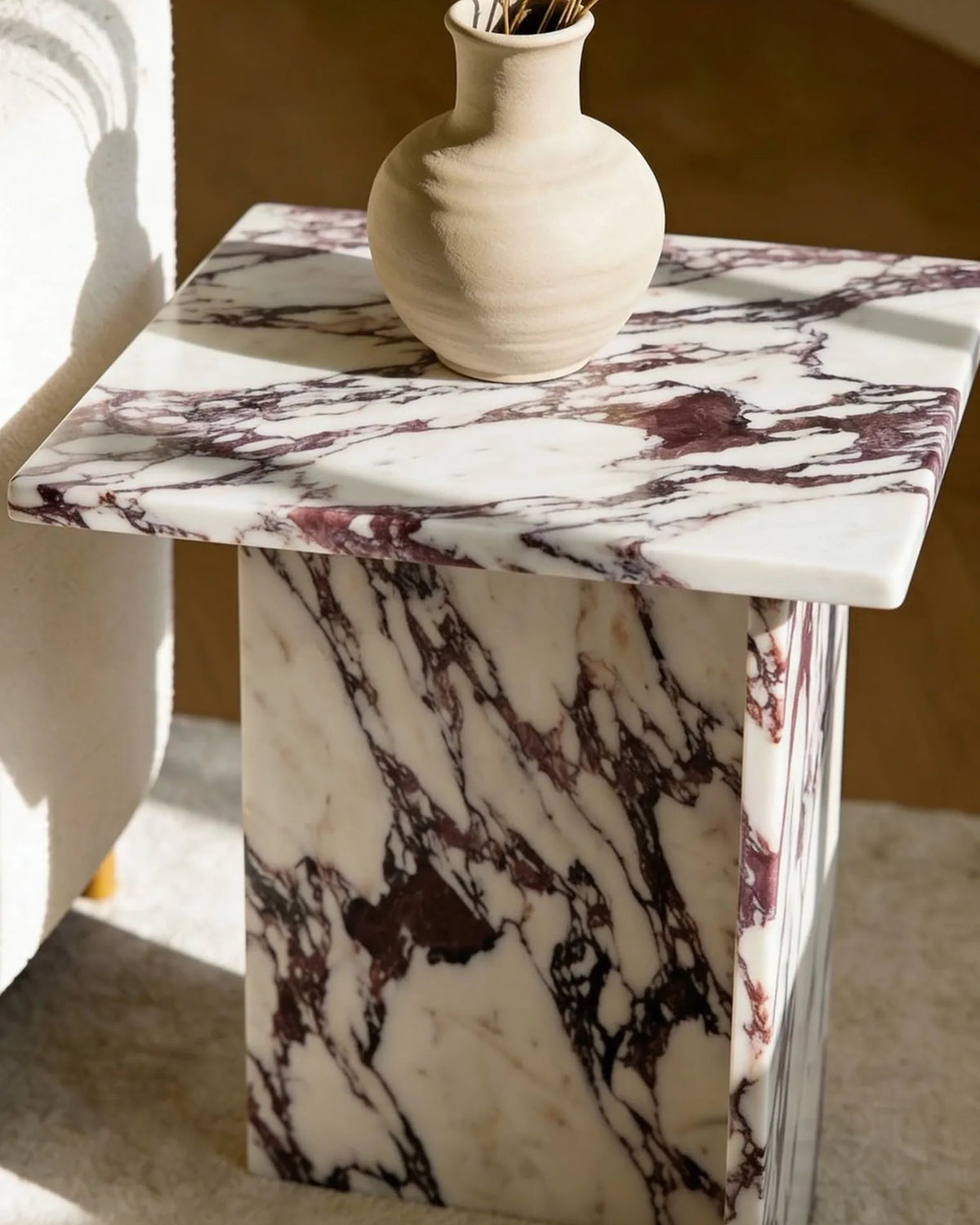 Calacatta marble side table, close-up of the grey veining
