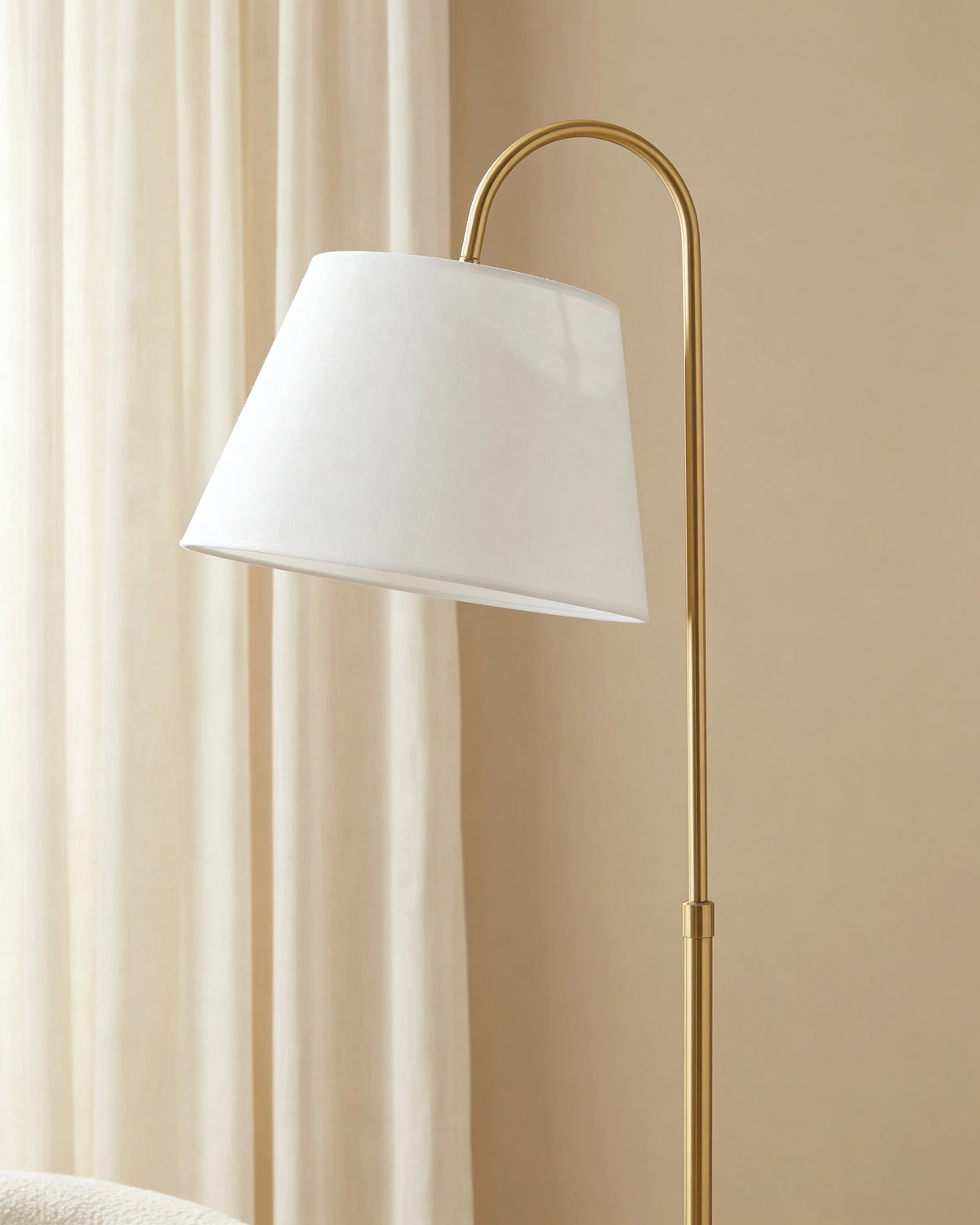 Gold arc floor lamp in a Dubai living room