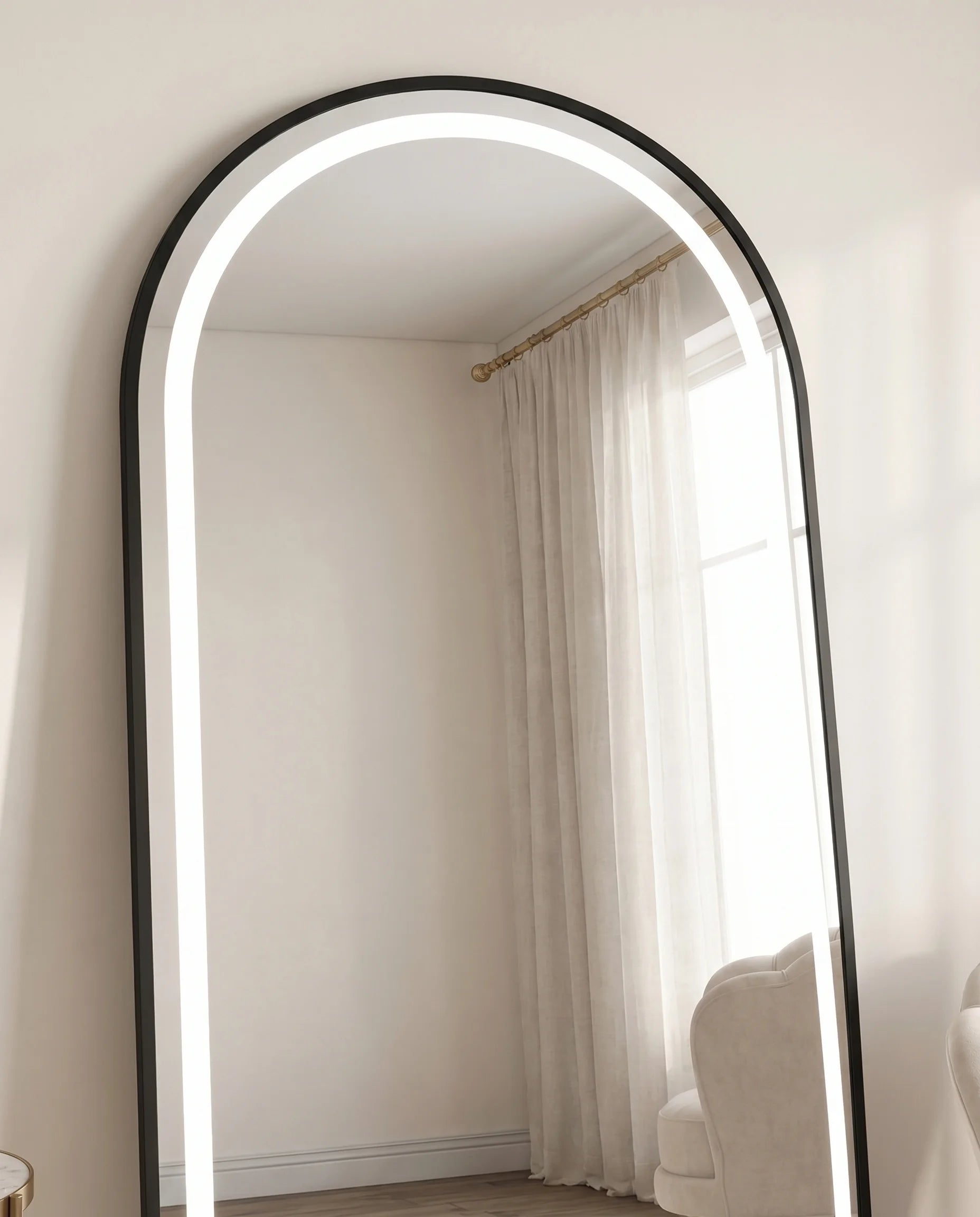 Raphael black LED arched wall mirror, close-up of the glow