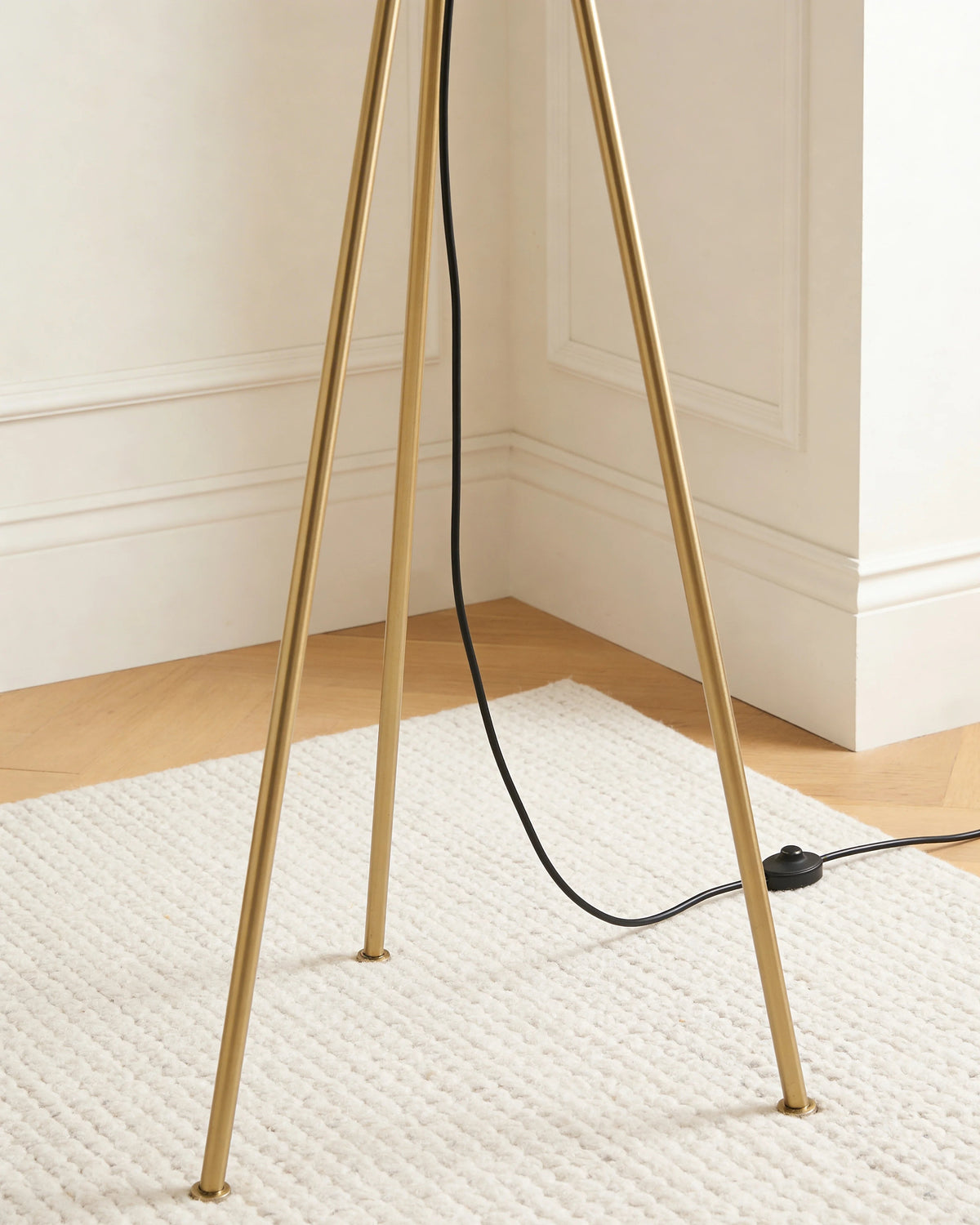 Sephora minimalist brass tripod floor lamp, close-up detail