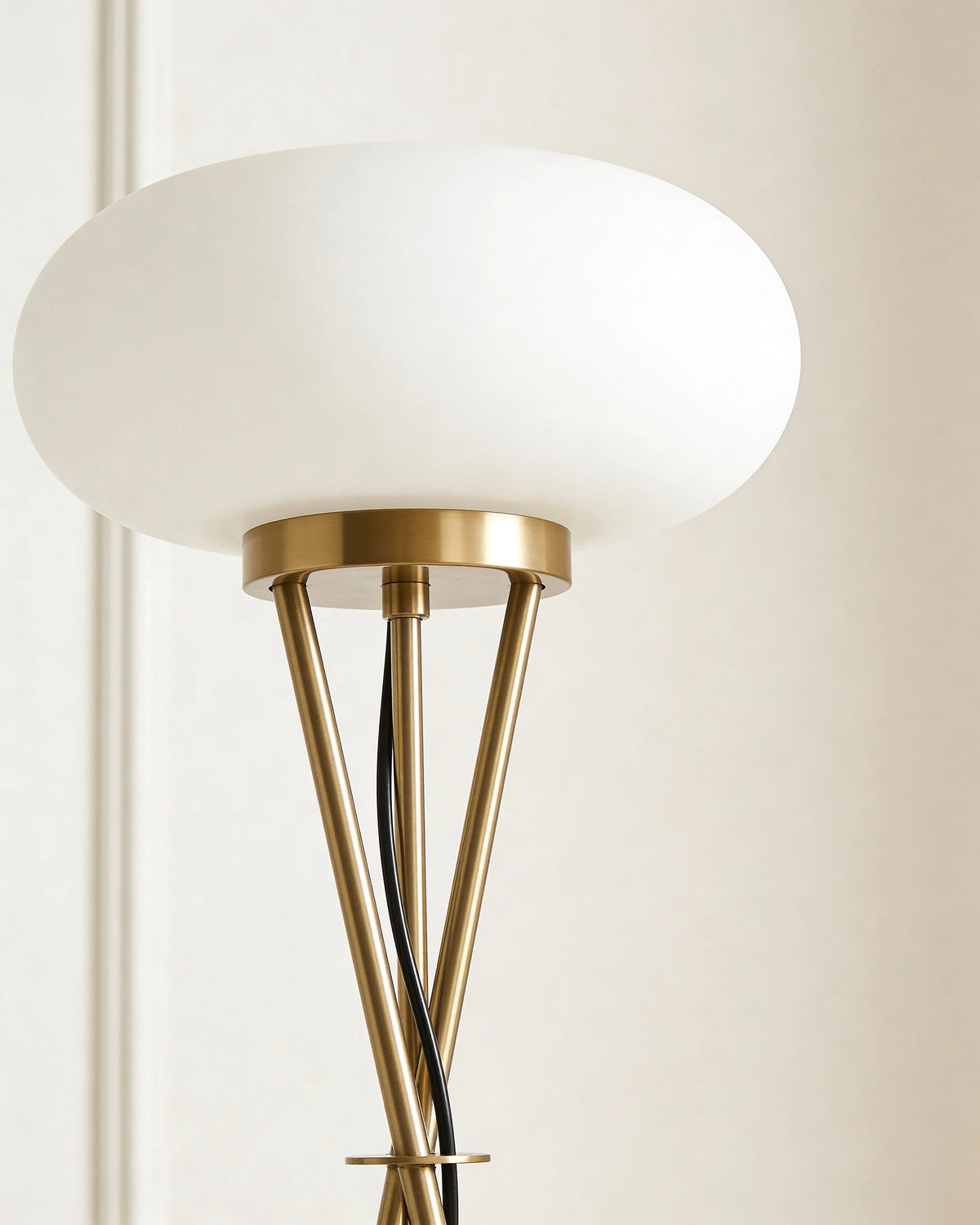 Brass tripod floor lamp in a Dubai living room