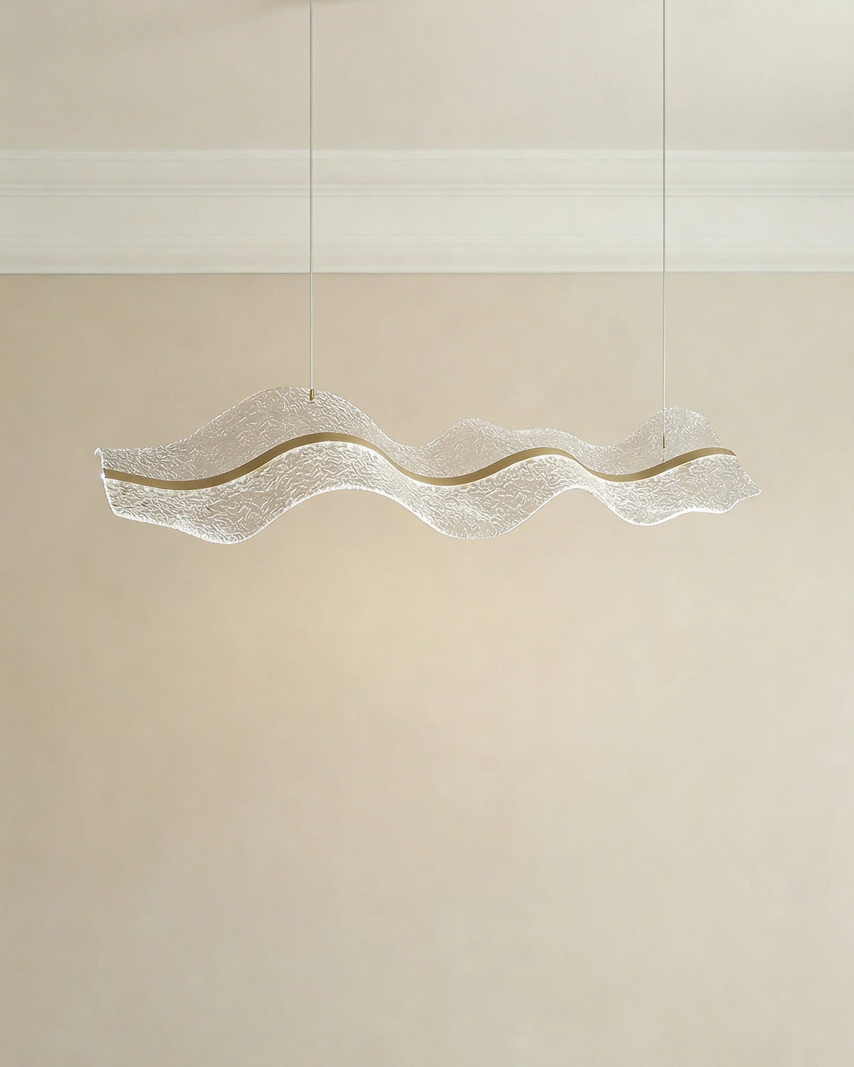 Gold pendant light over a Dubai dining table