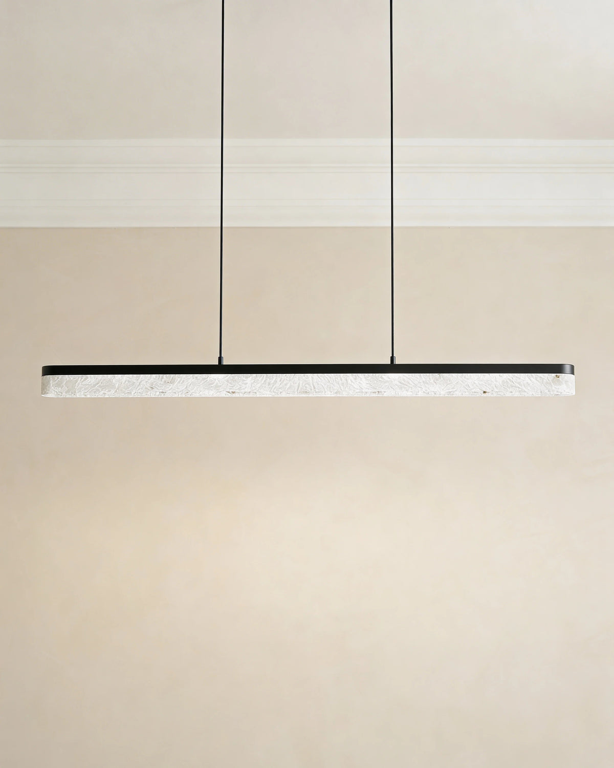 Black crystal island light over a Dubai dining table