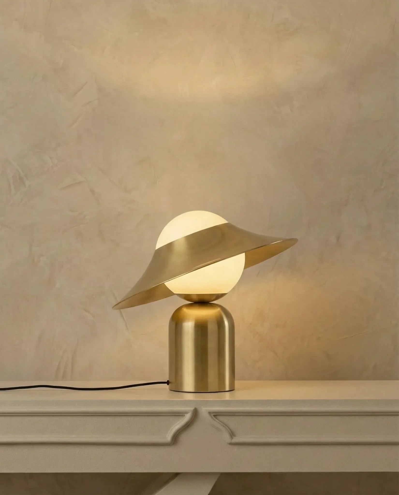 Gold glass table lamp, close-up of the tilted shade