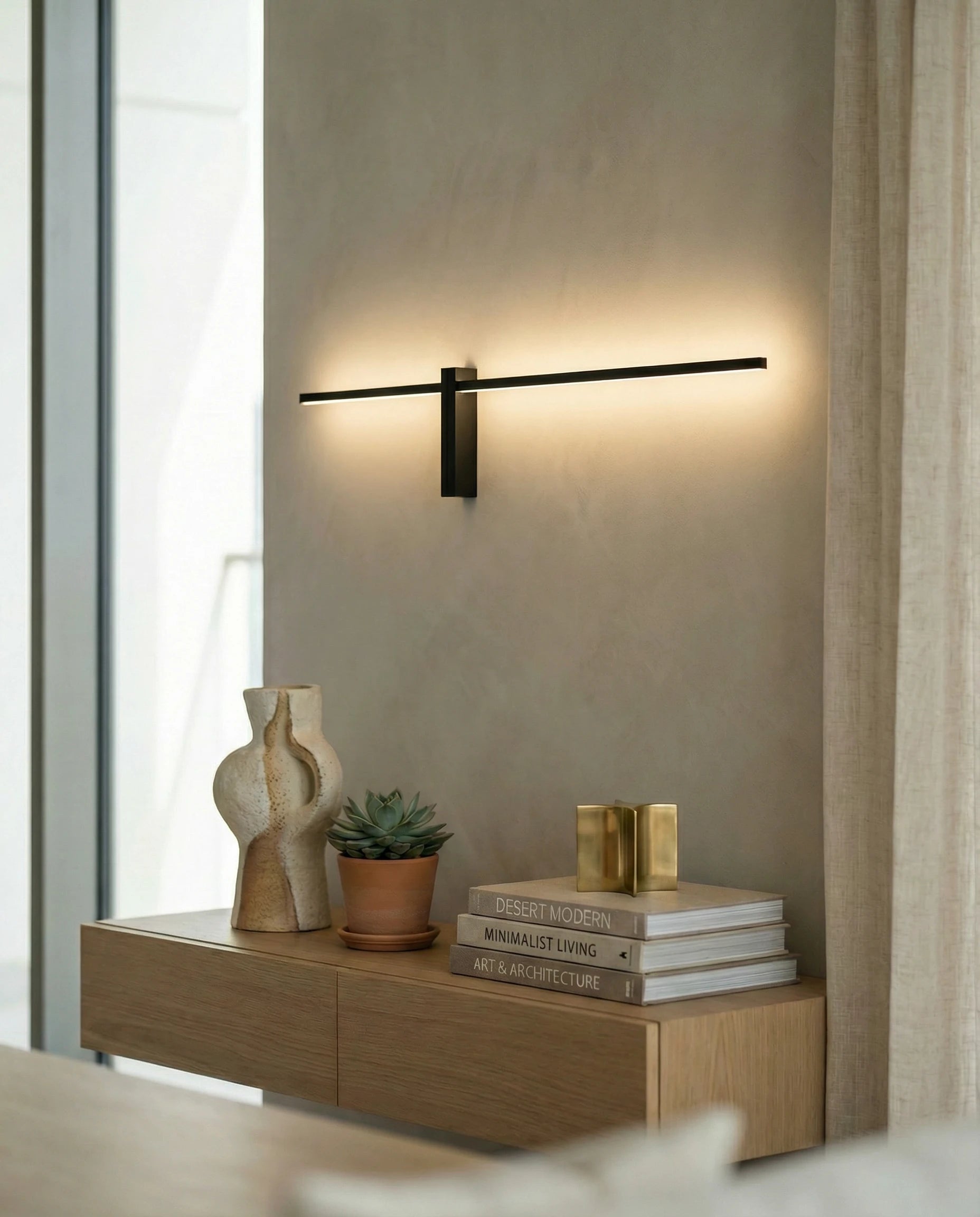 Black tube wall light on a Dubai living-room wall