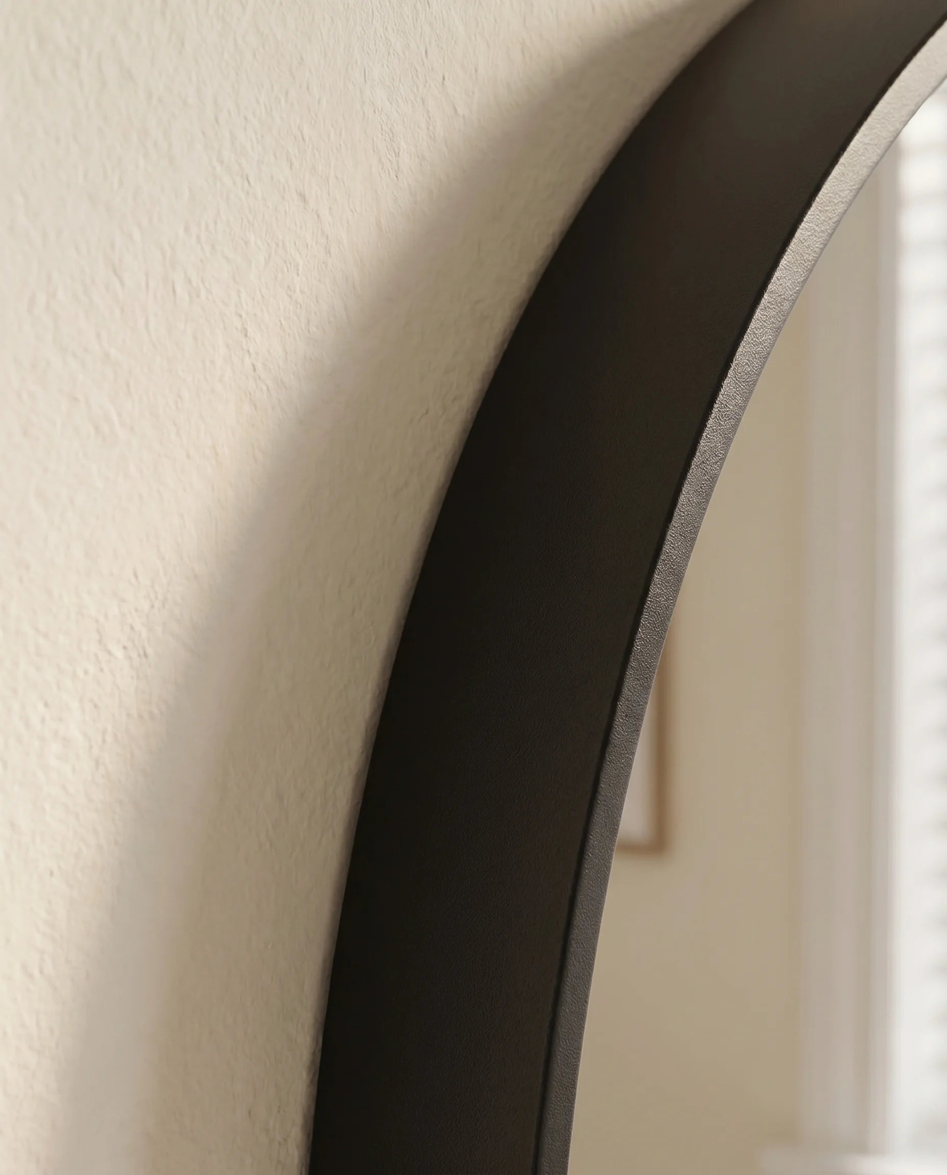 Avery black round accent wall mirror in a Dubai hallway