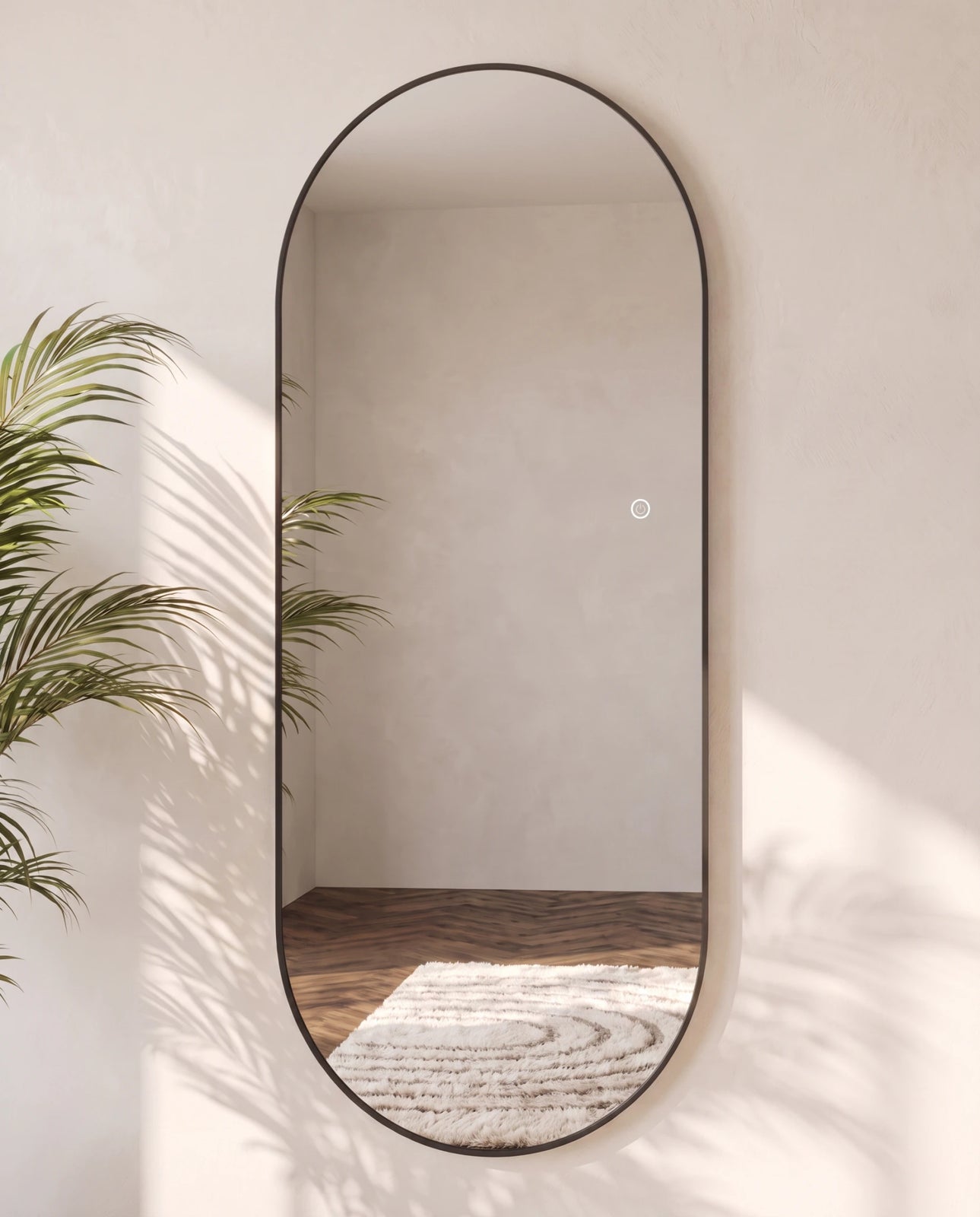 Elara black backlit oval wall mirror, close-up of the backlit edge