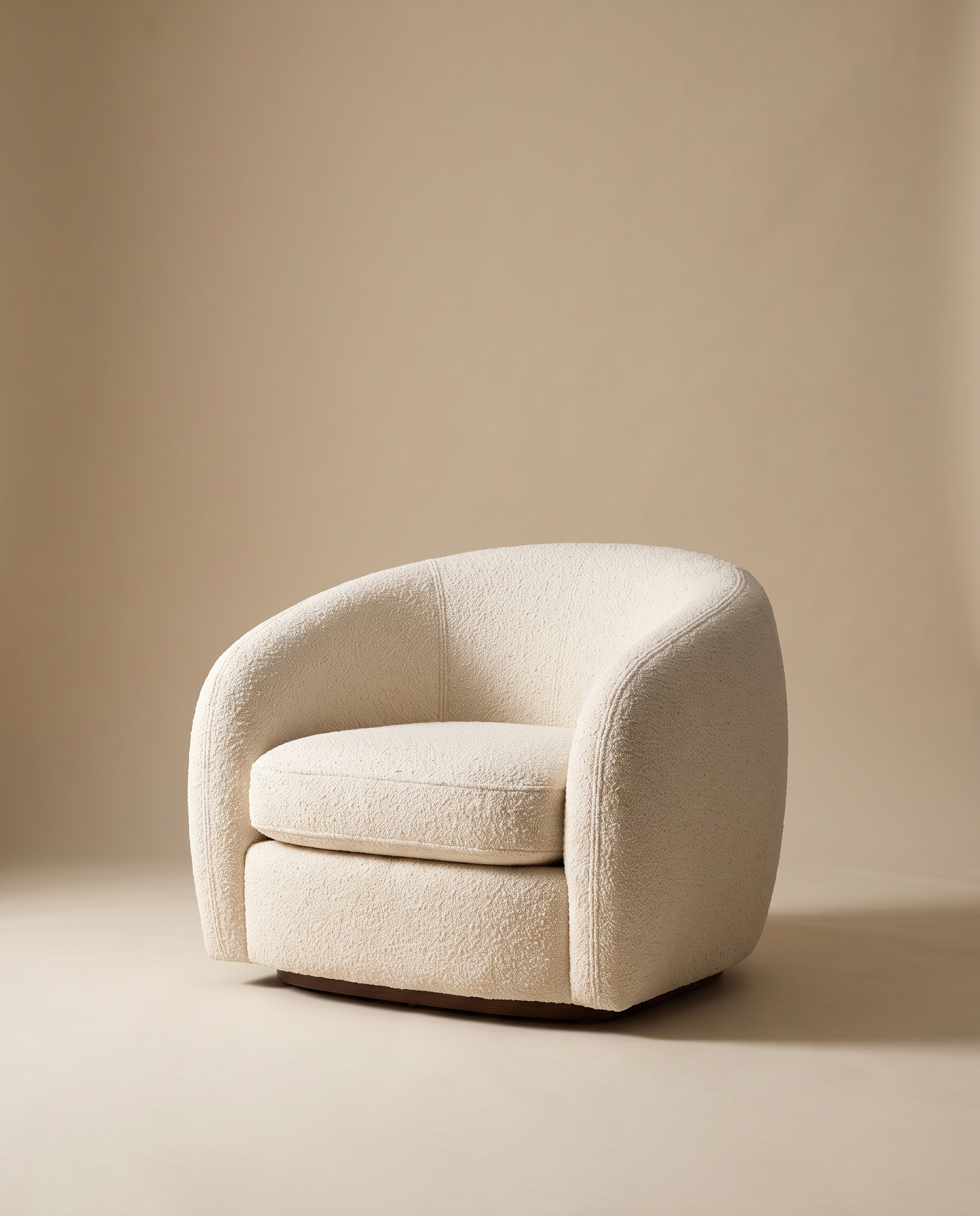 Elise cream bouclé curved armchair on a warm oat studio backdrop