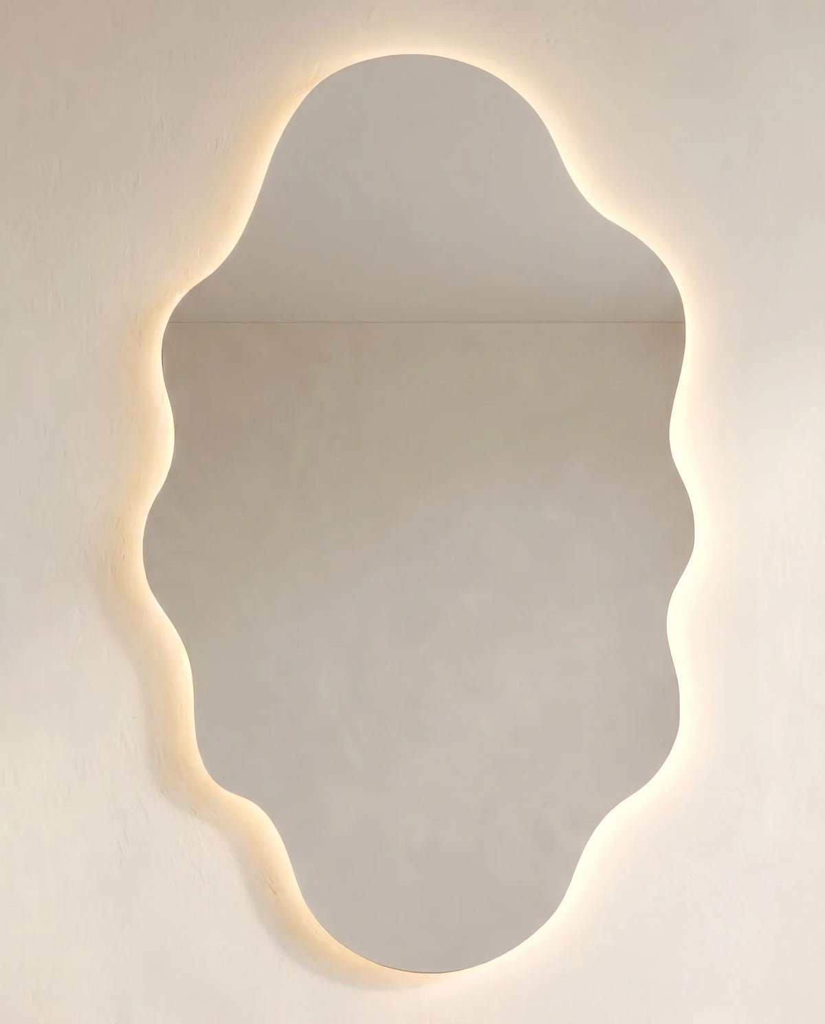Elodie LED frameless cloud mirror on a Dubai feature wall
