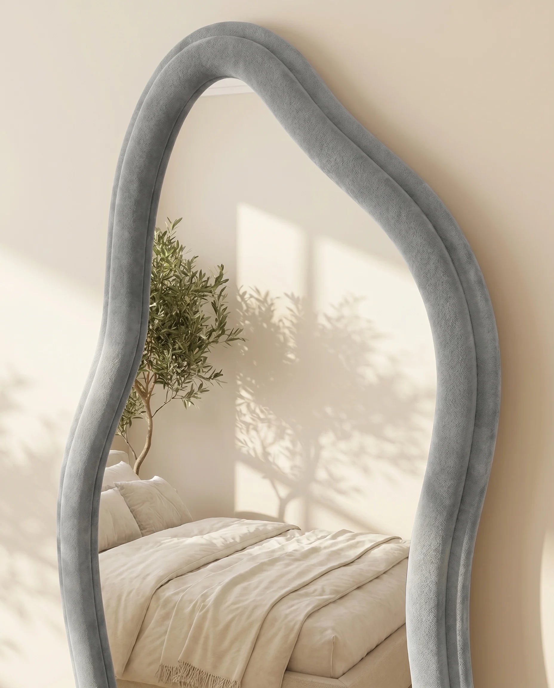 Ottilie grey irregular mirror, close-up of the soft fabric frame