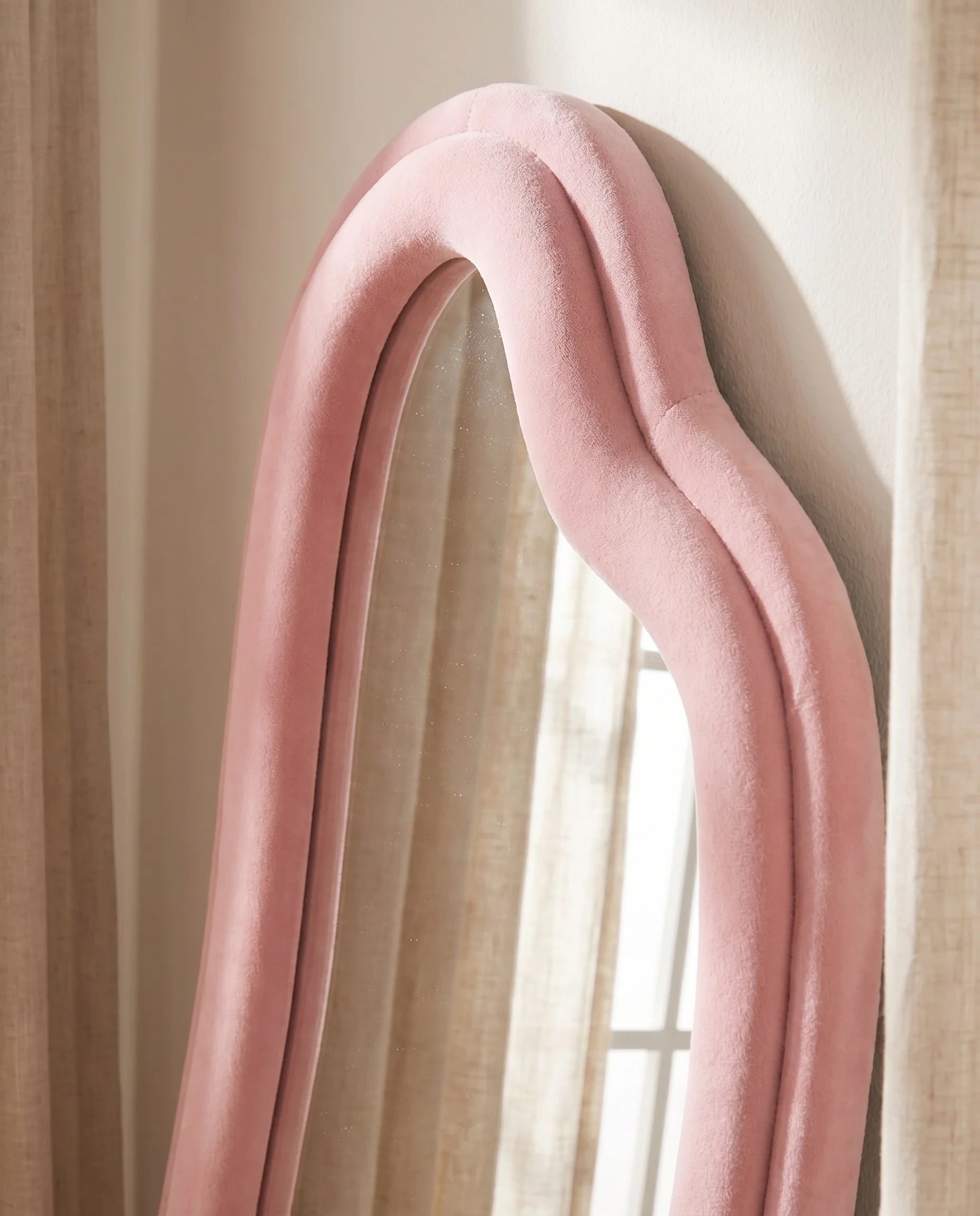 Ottilie pink irregular mirror, close-up of the soft fabric frame