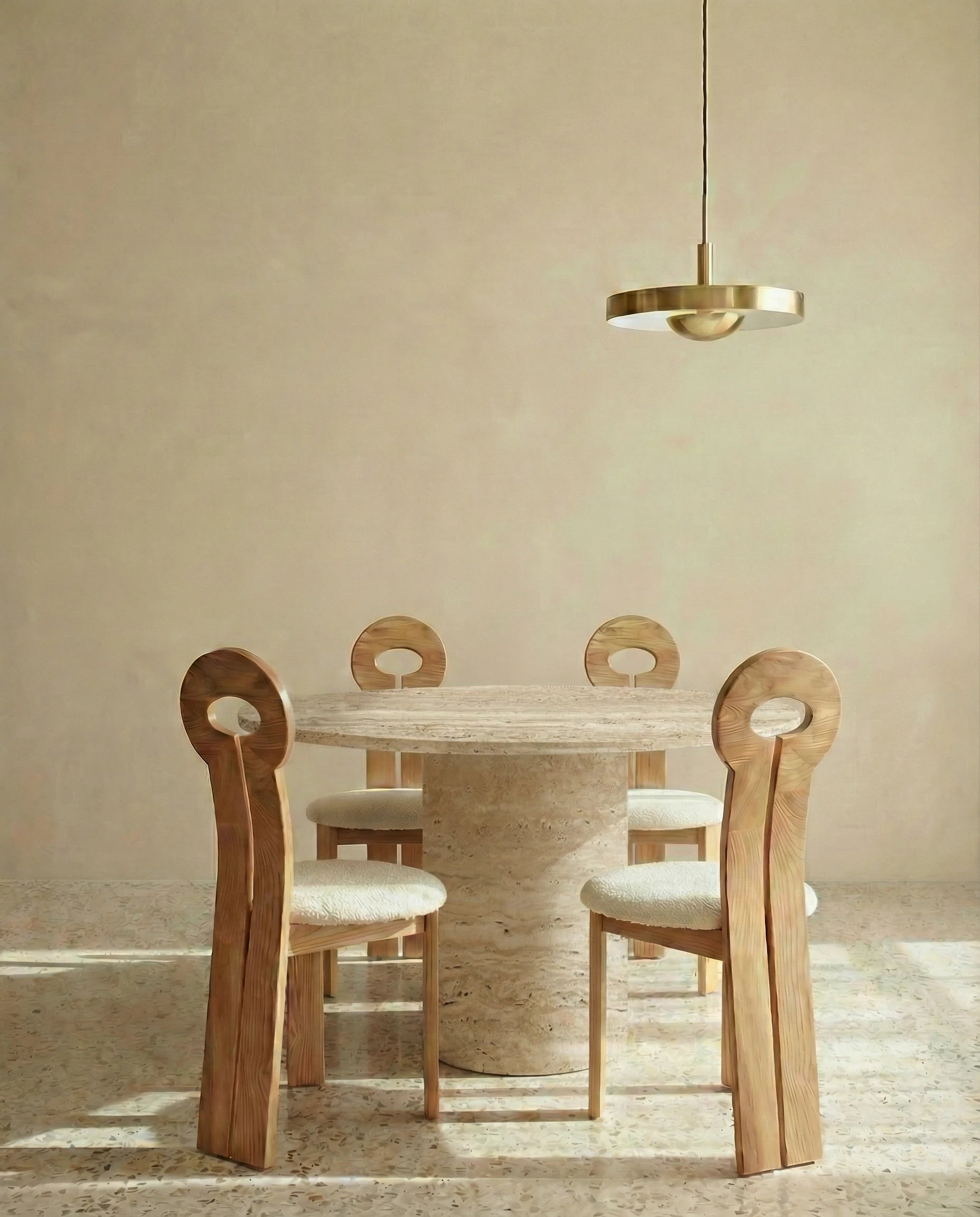 Round travertine dining table, close-up of the warm beige stone