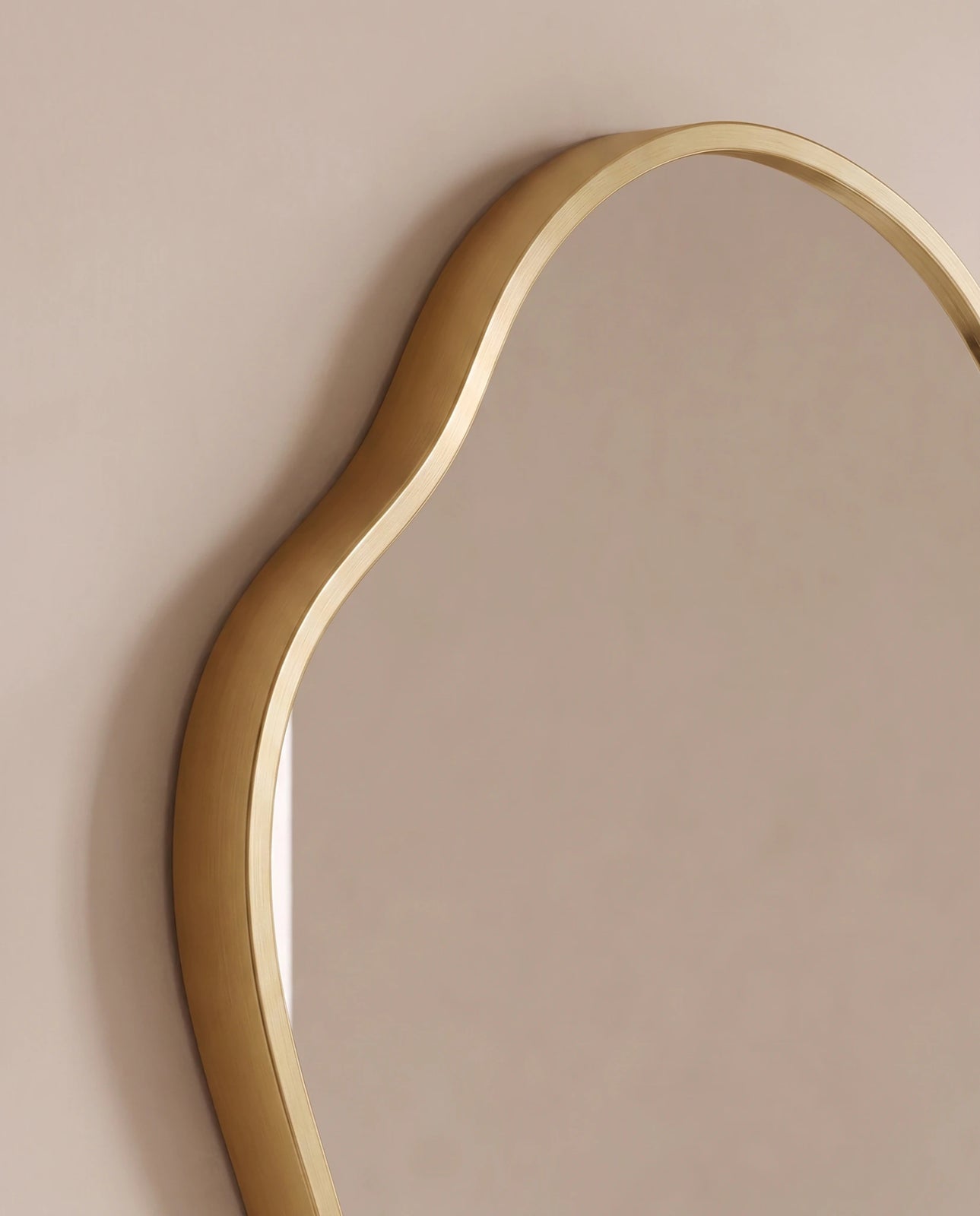 Vela gold irregular wall mirror in a Dubai living room