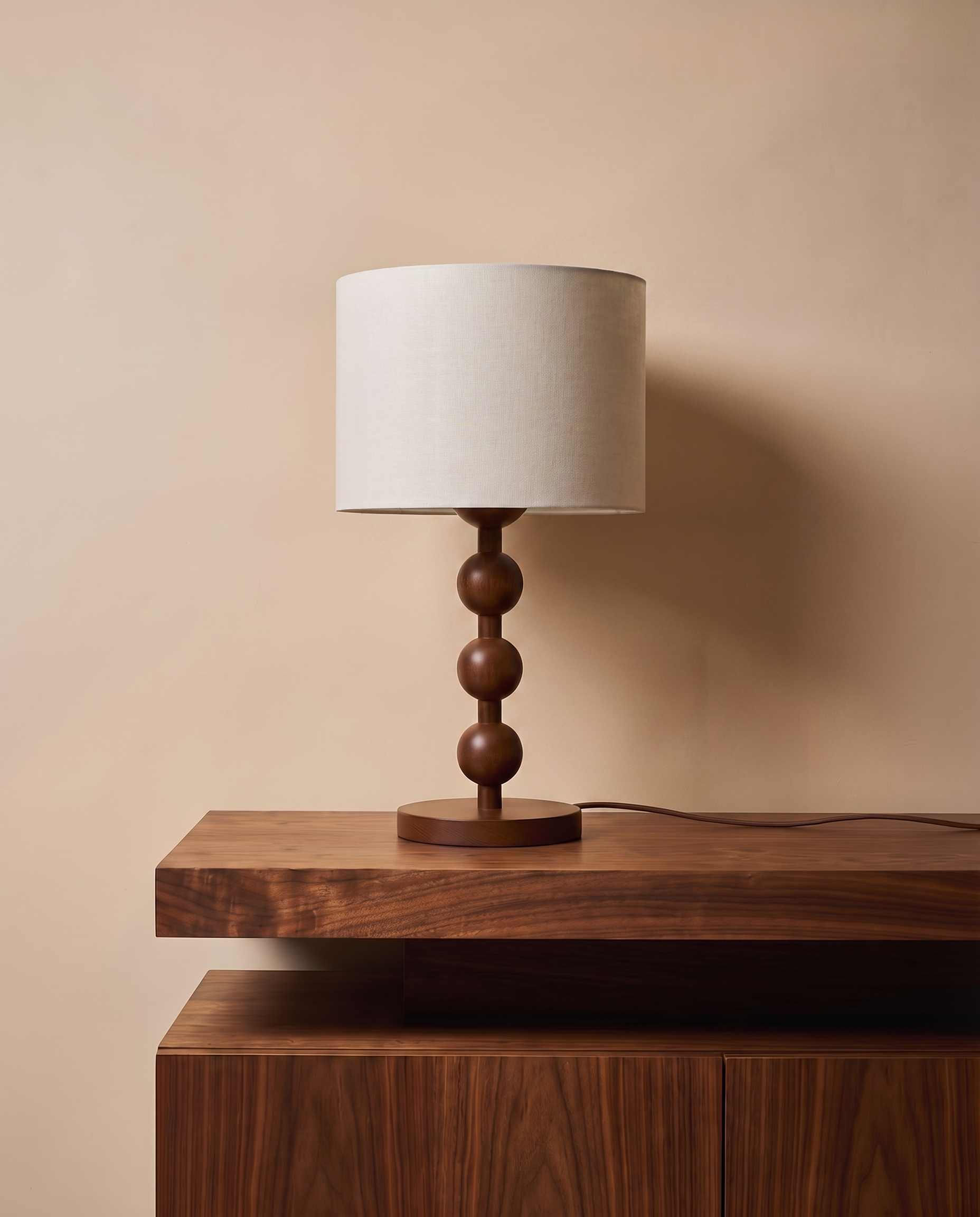 Dark wood table lamp with off-white shade