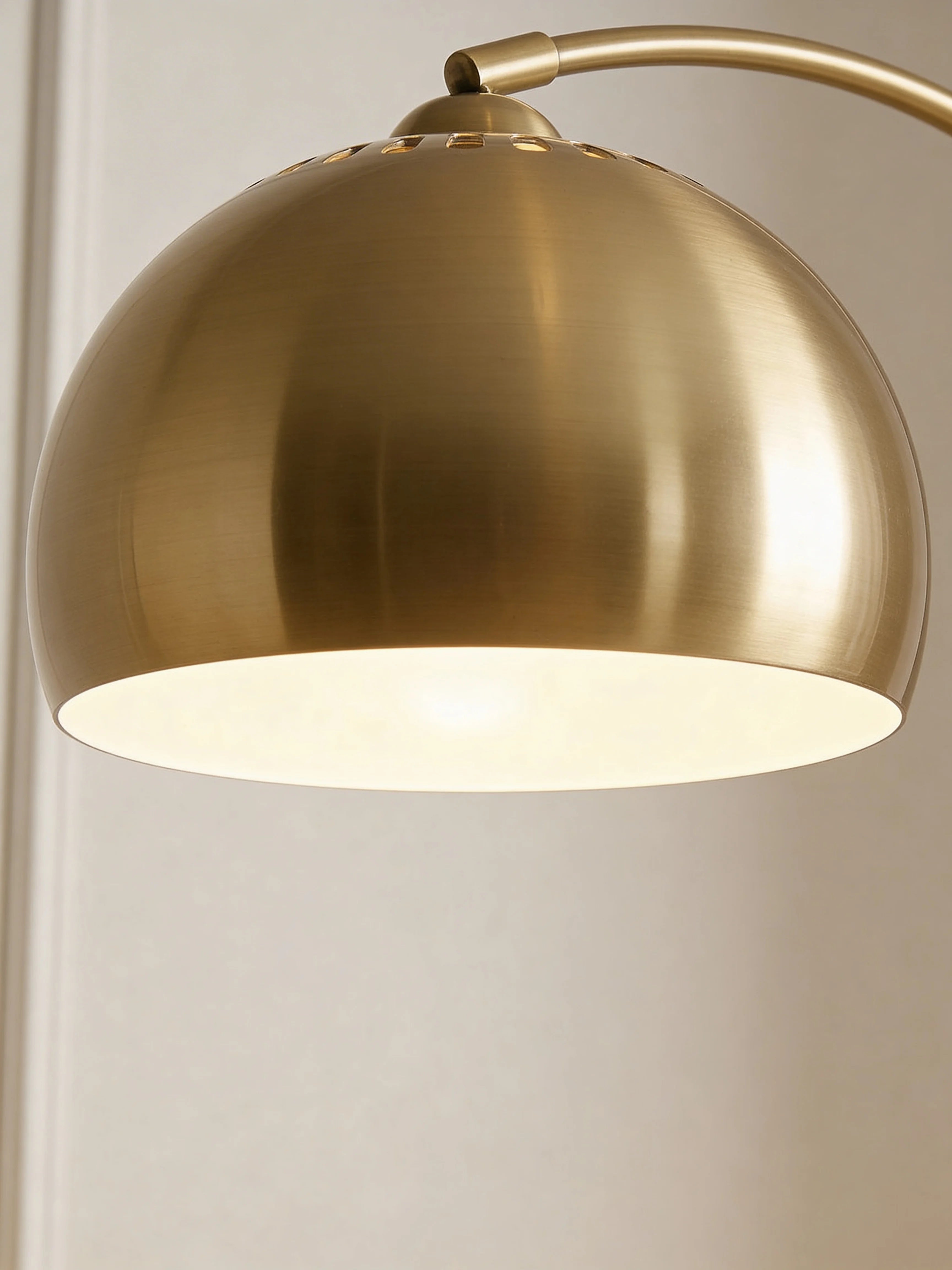 Gold arc floor lamp in a Dubai living room