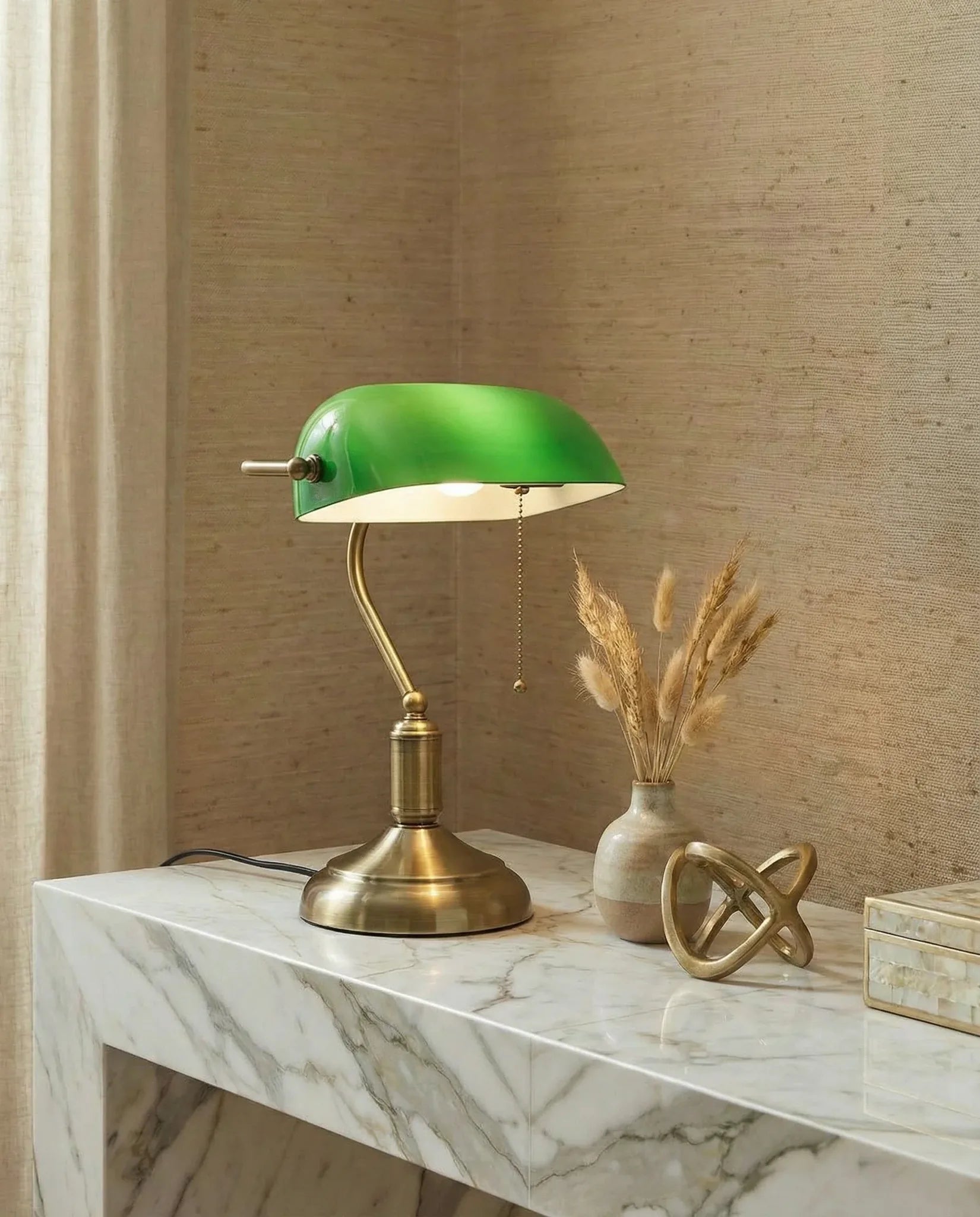 Antique banker's green glass table lamp on a desk