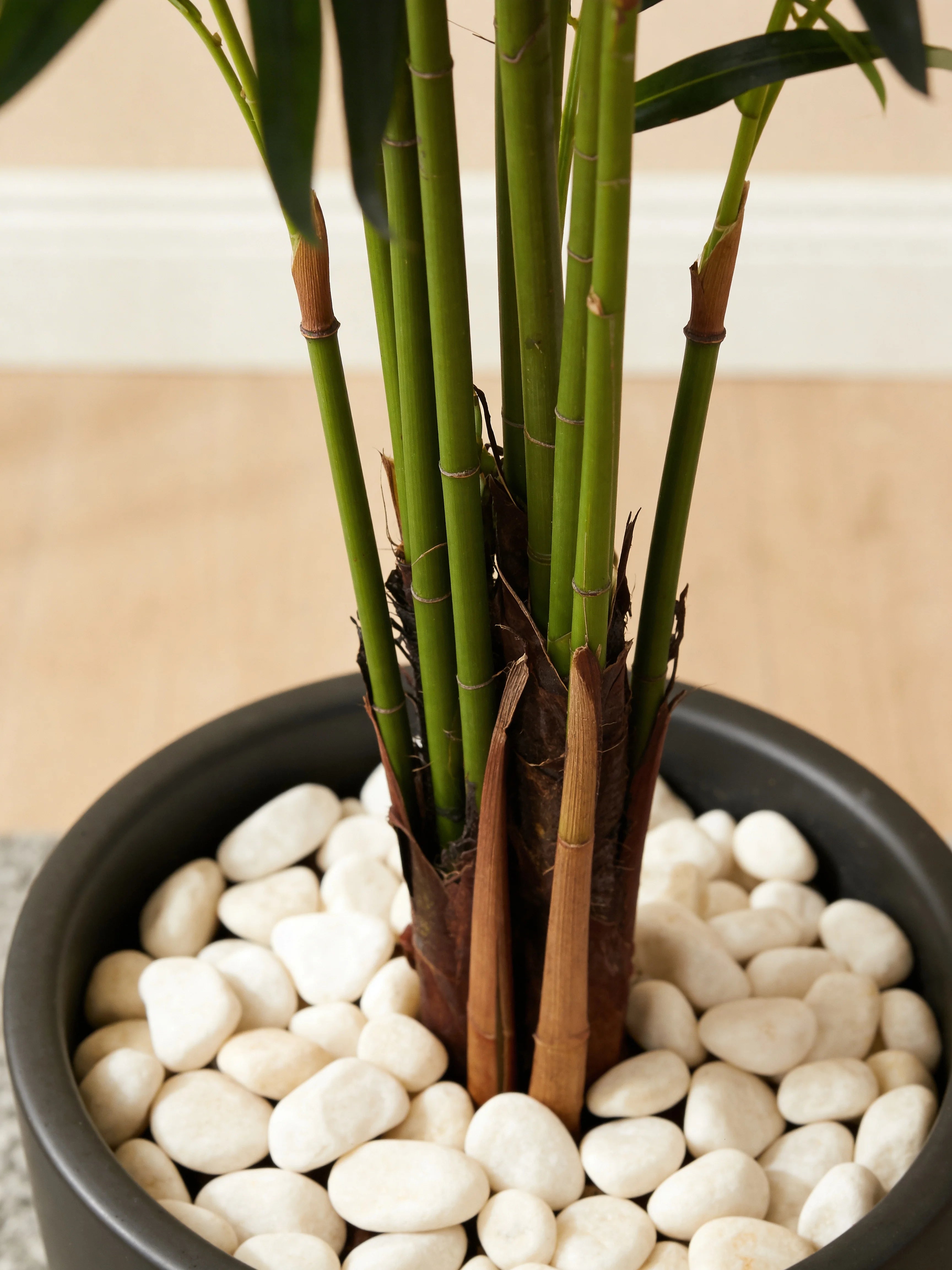 Artificial weeping bamboo plant with green stems in a Dubai living room