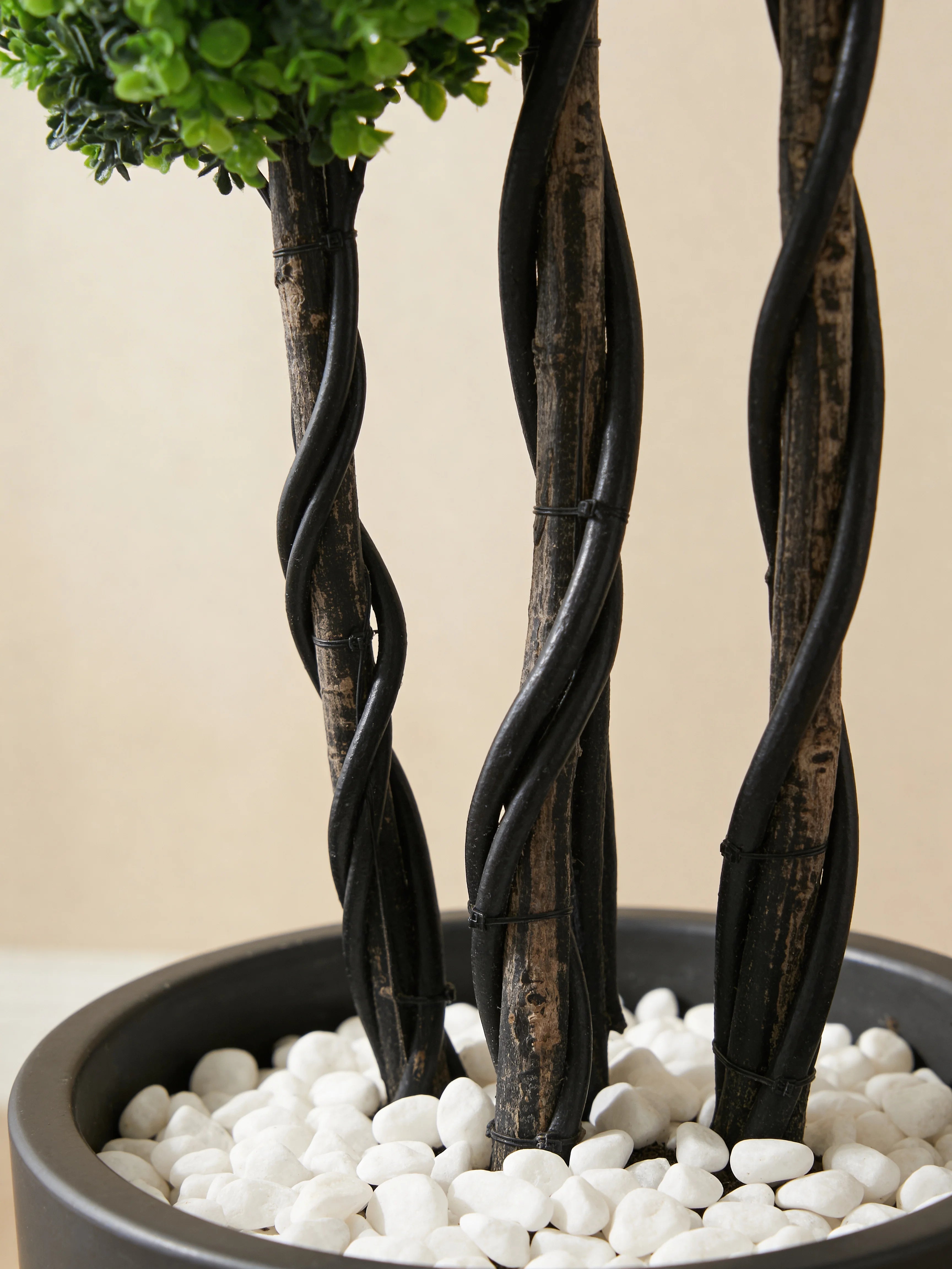 4-tier boxwood moss ball topiary tree in a Dubai living room