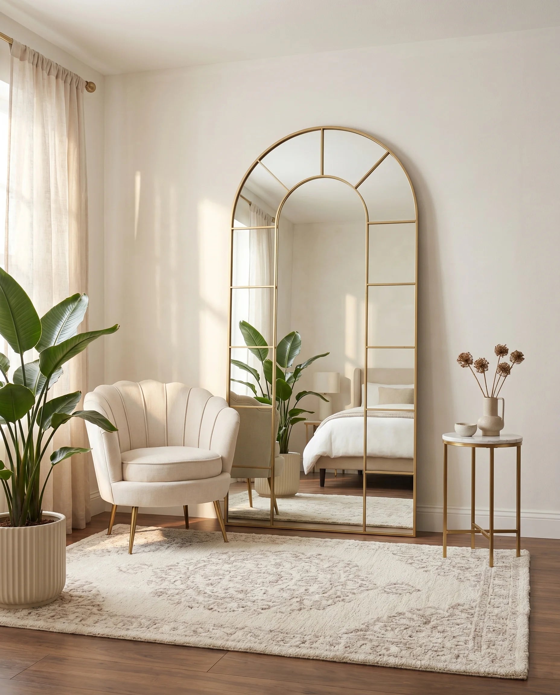 Charles tall gold window-pane arched mirror in a Dubai living room
