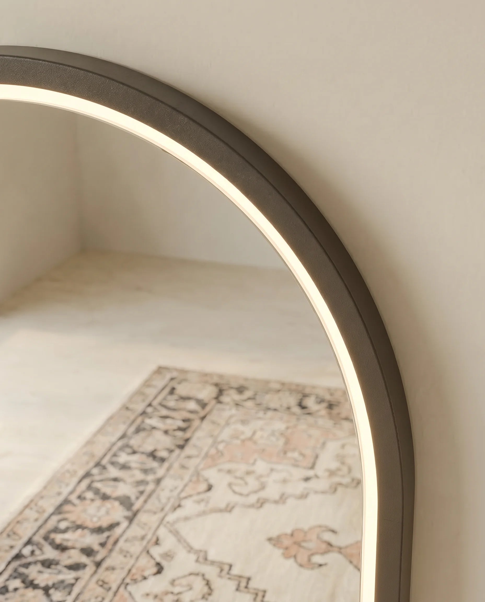 Iris black LED arch mirror, close-up of the touch light control