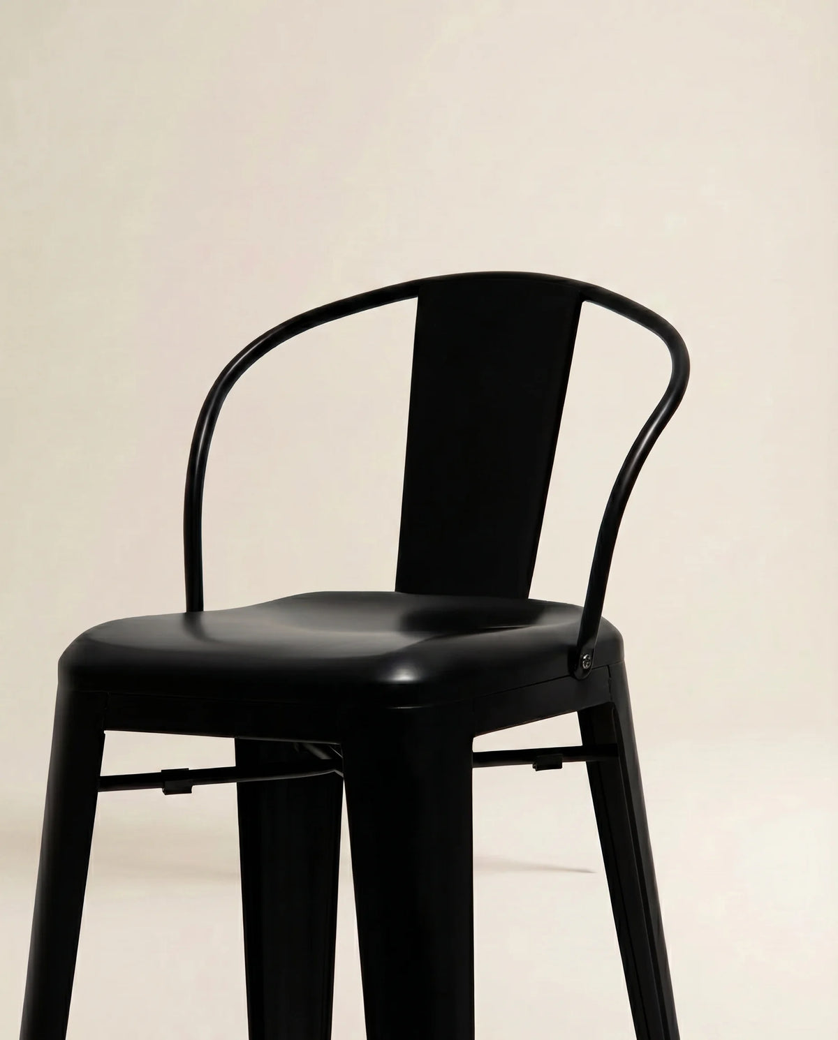 Black metal bar stool, close-up of the matte frame