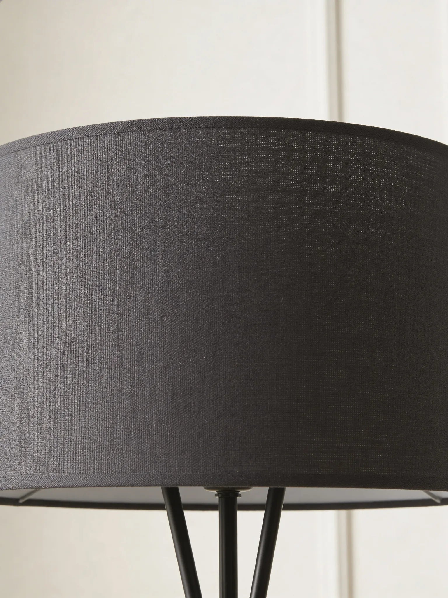 Black tripod floor lamp in a Dubai living room