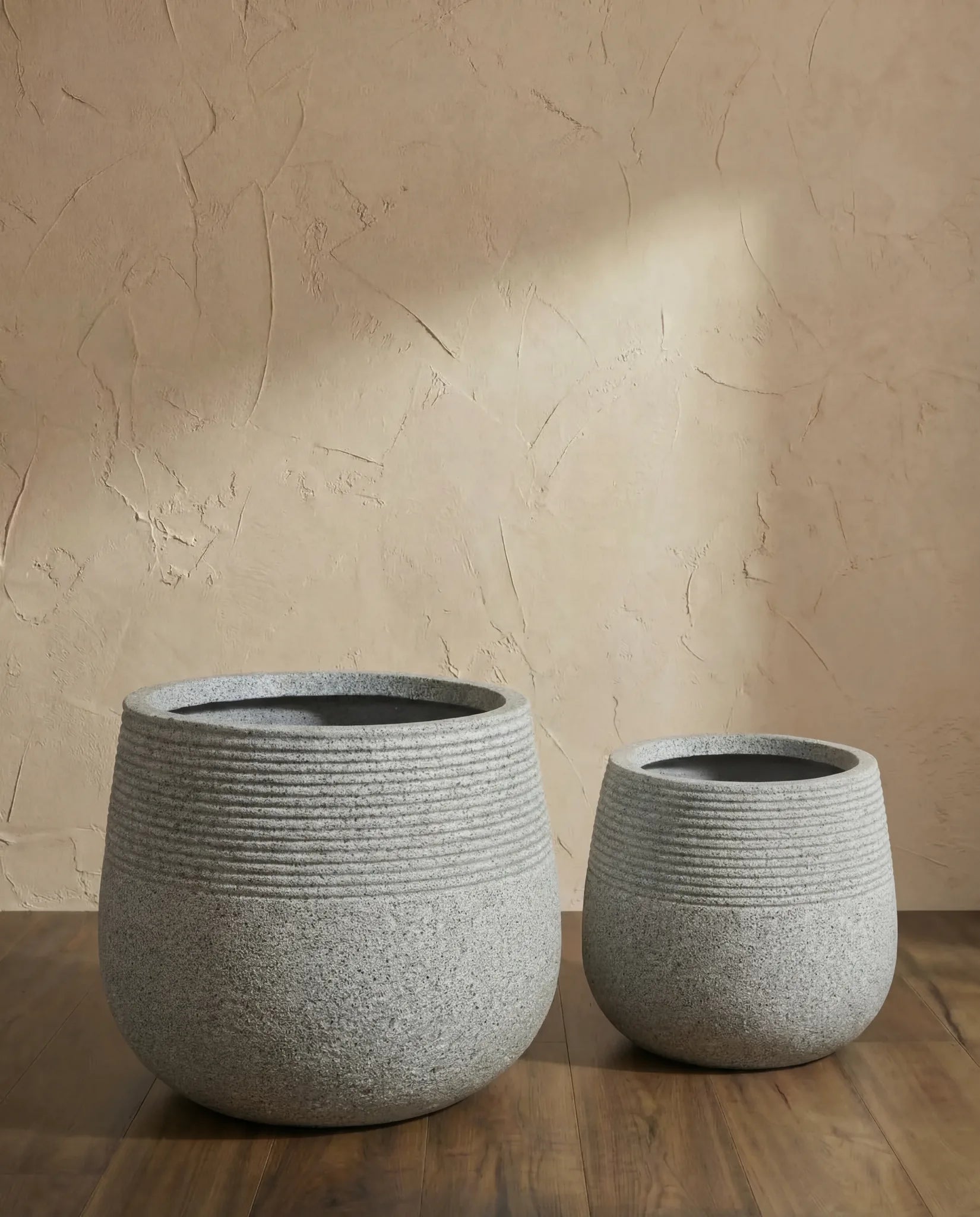 Taxila Grey Rounded Textured Fibreclay Pot in a Dubai living room