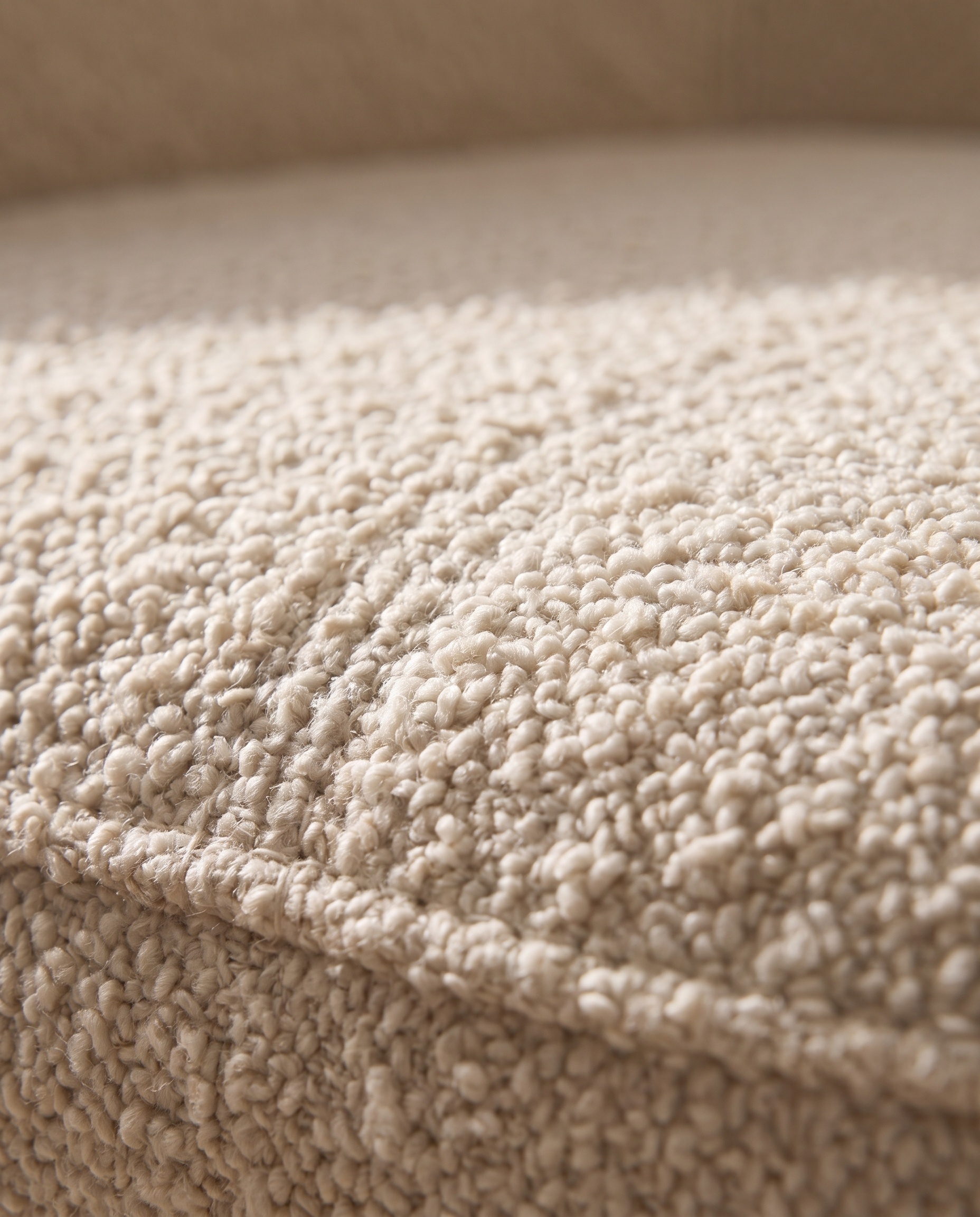 Close-up of the looped bouclé fabric on the Elise armchair