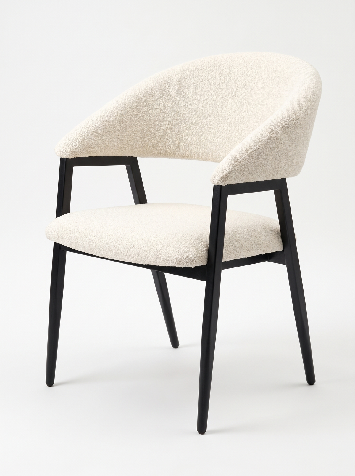 Celeste cream bouclé dining chair with curved backrest and black tapered legs